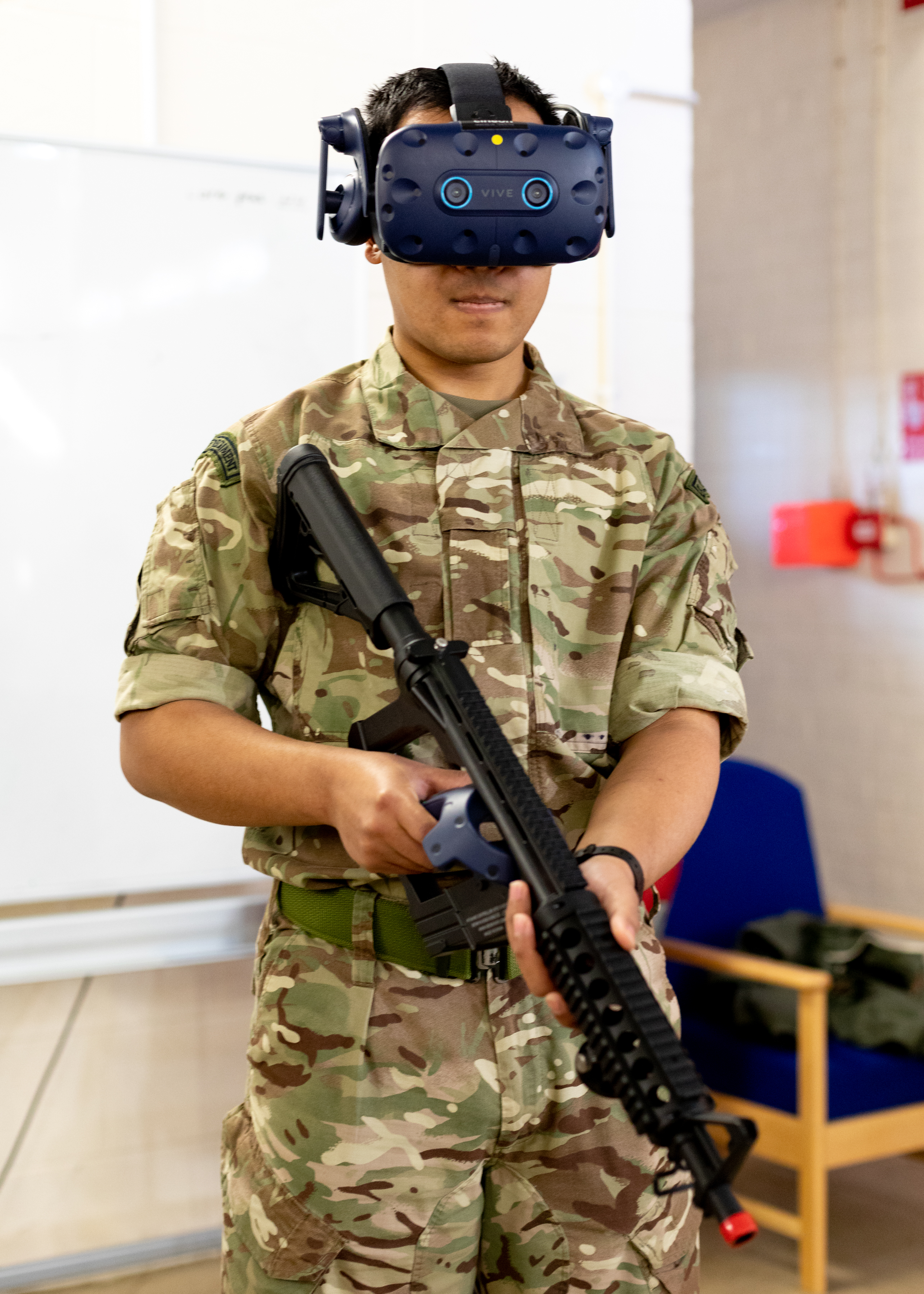 Image shows aviator holding rifle and wearing Virtual Reality headset.