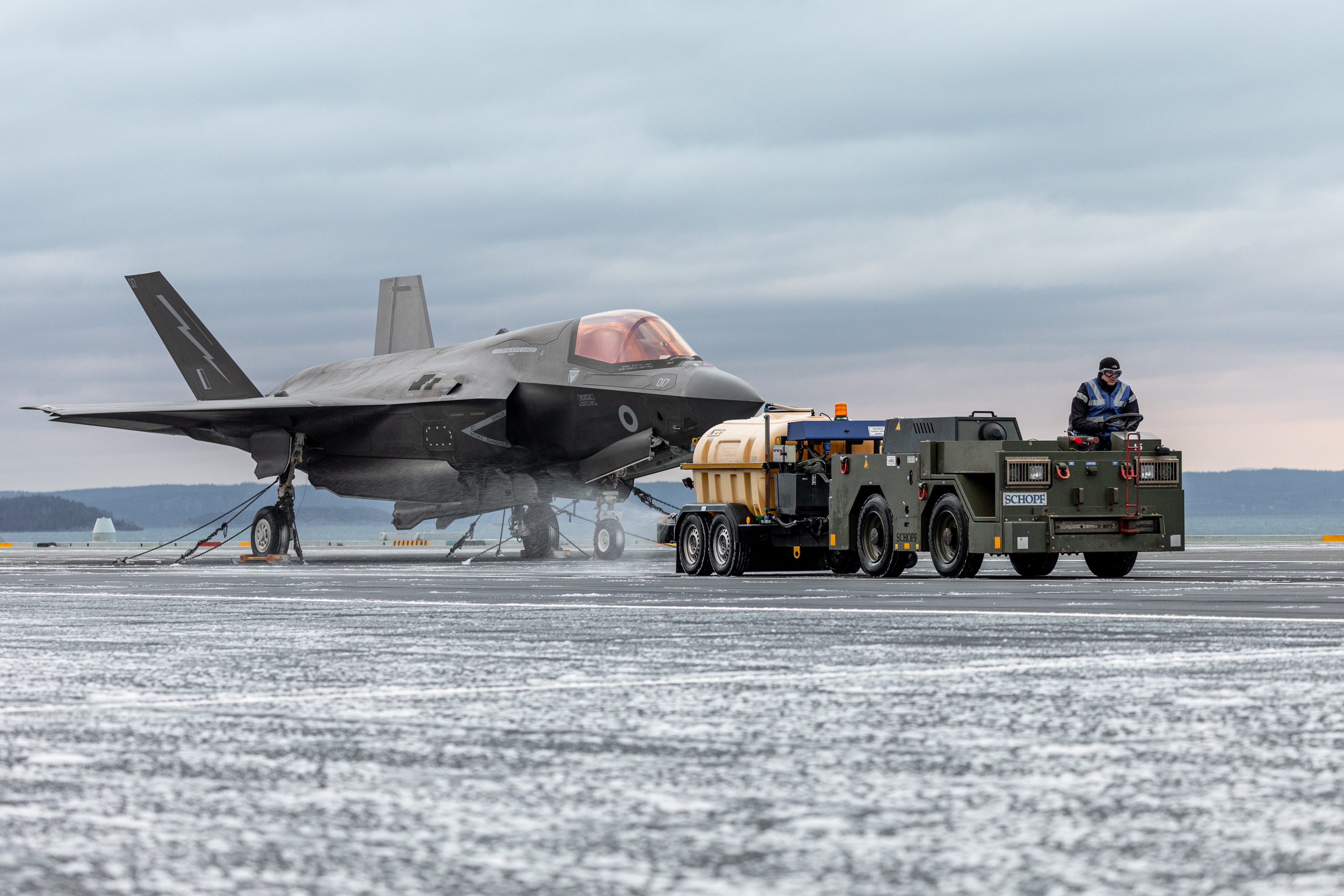Image shows RAF Lightning aircraft on the airfield with truck.