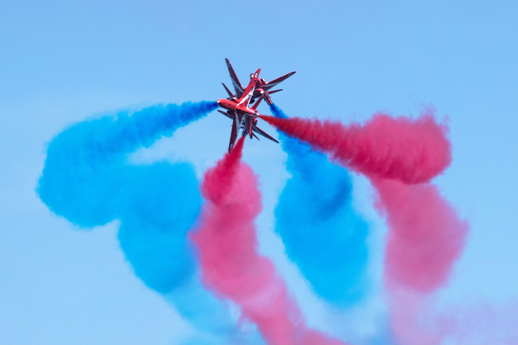 Four Red Arrows perform with display smoke.