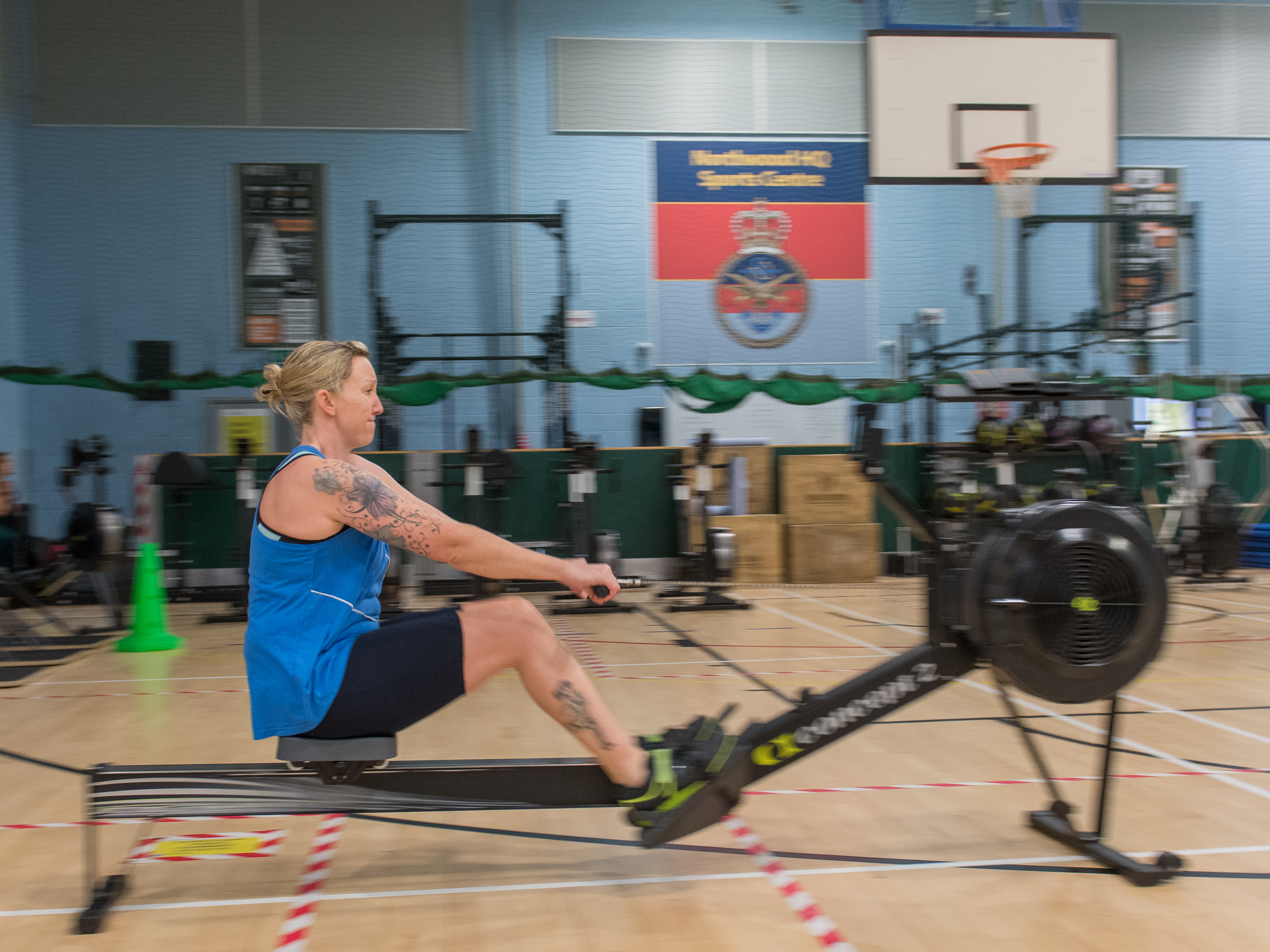 Personnel uses a rowing machine in the gym.