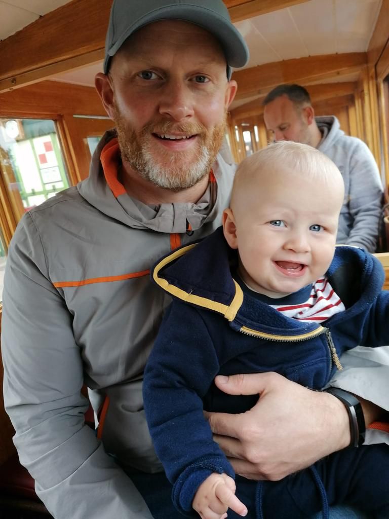 Nathan holds his son.