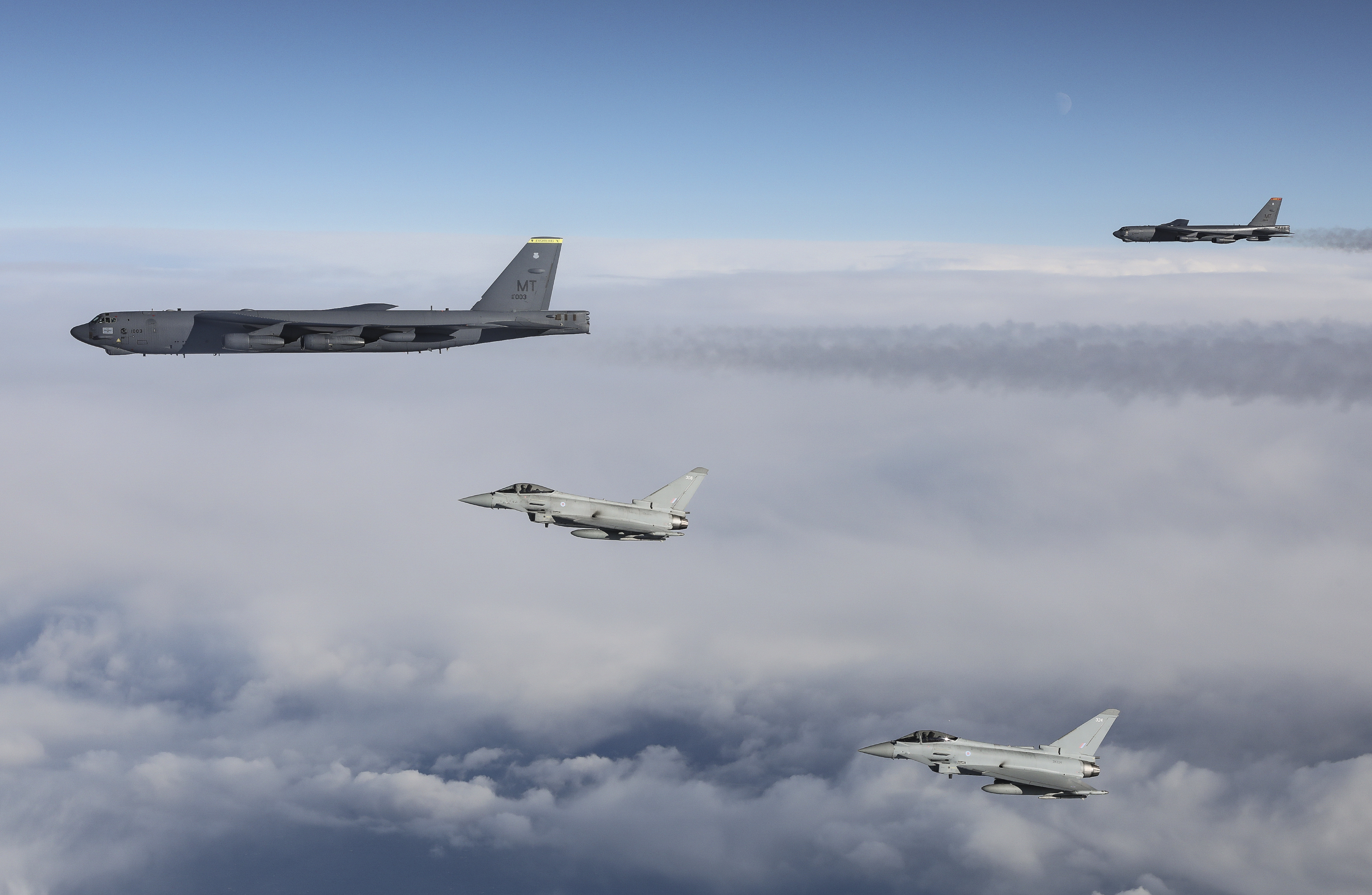 RAF Lightning jets in flight with US B-52's.