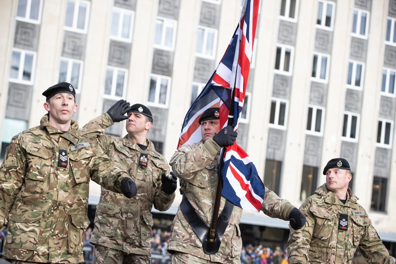 Personnel salute and carry Union Jack colour.