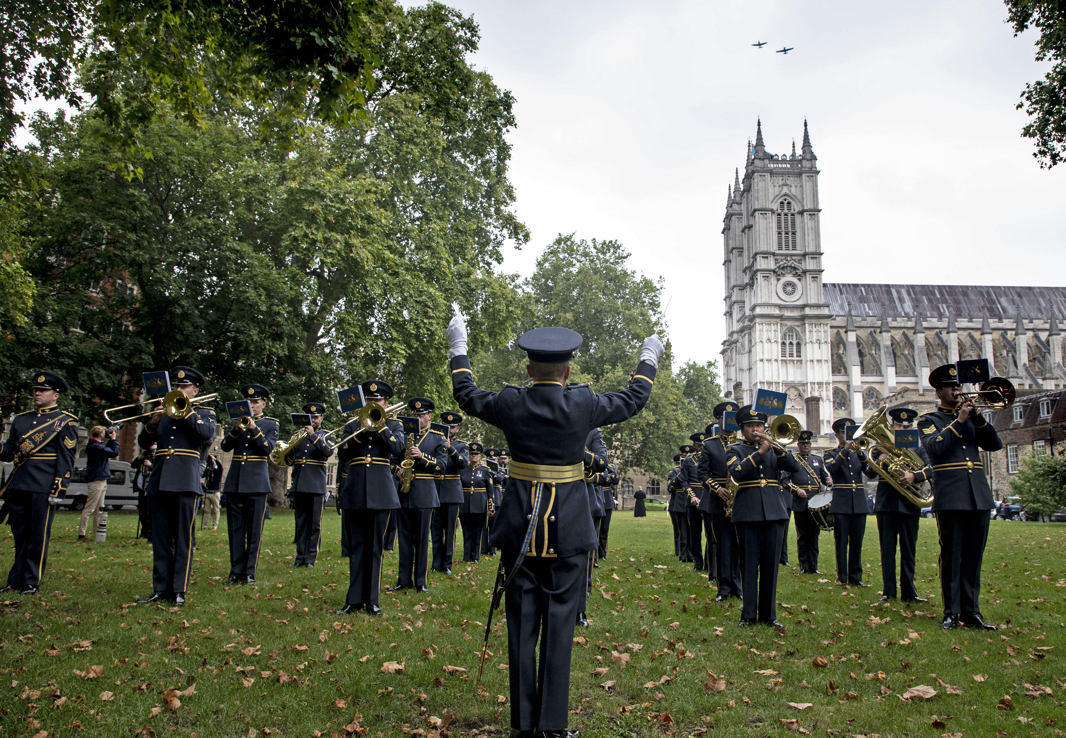 Band perform under flypast over Westminster Abbey. 