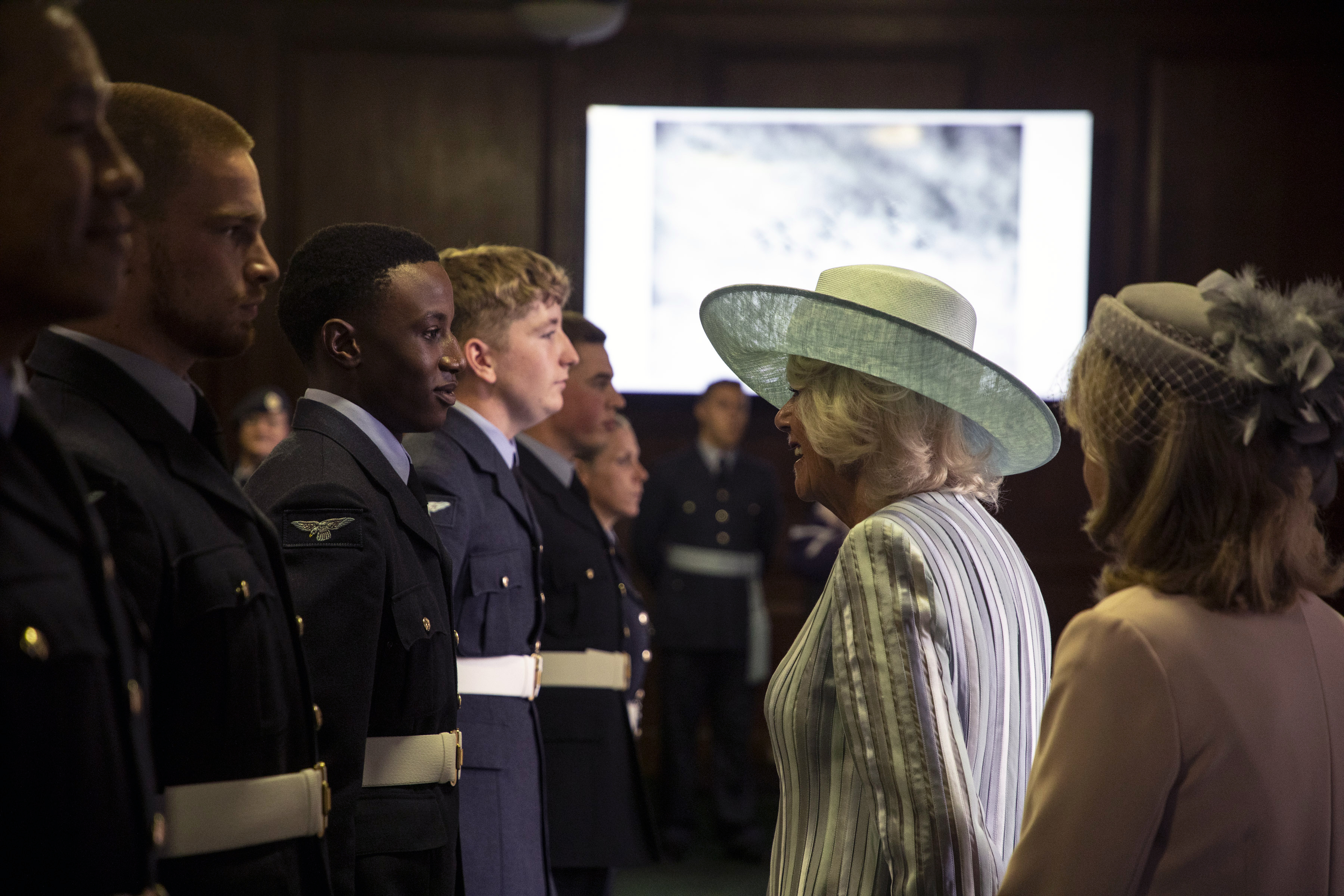 Her Royal Highness speaks with personnel.