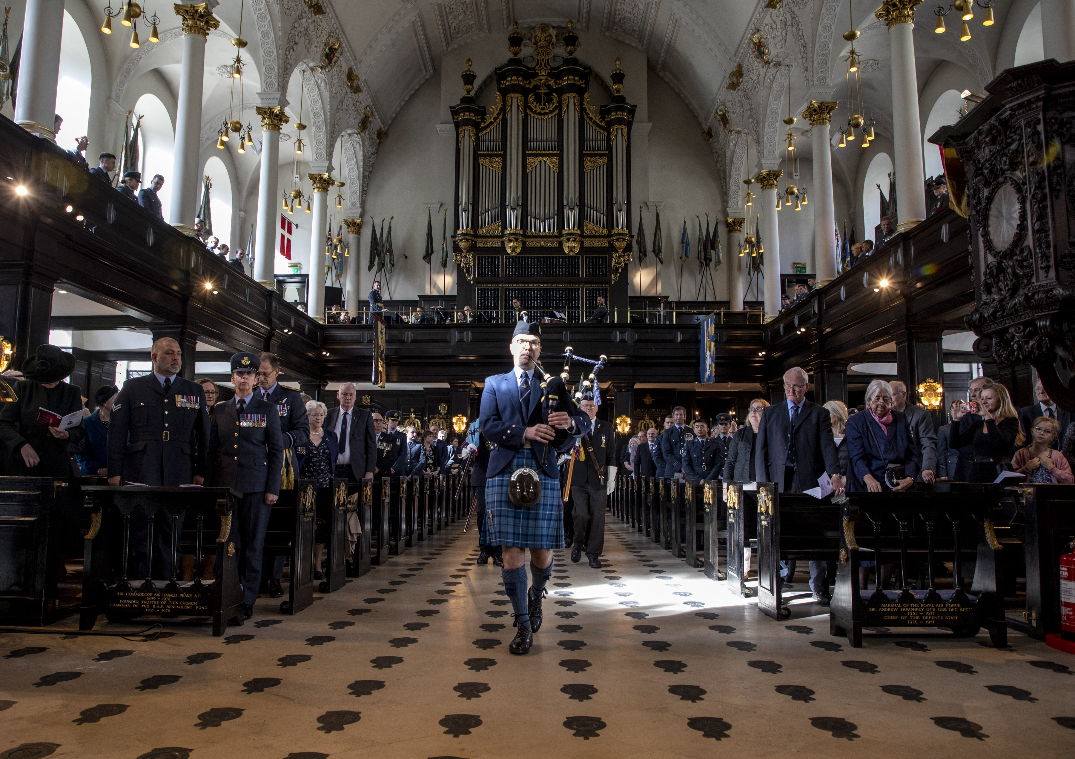 Personnel inside the church perform the service with bagpipes.