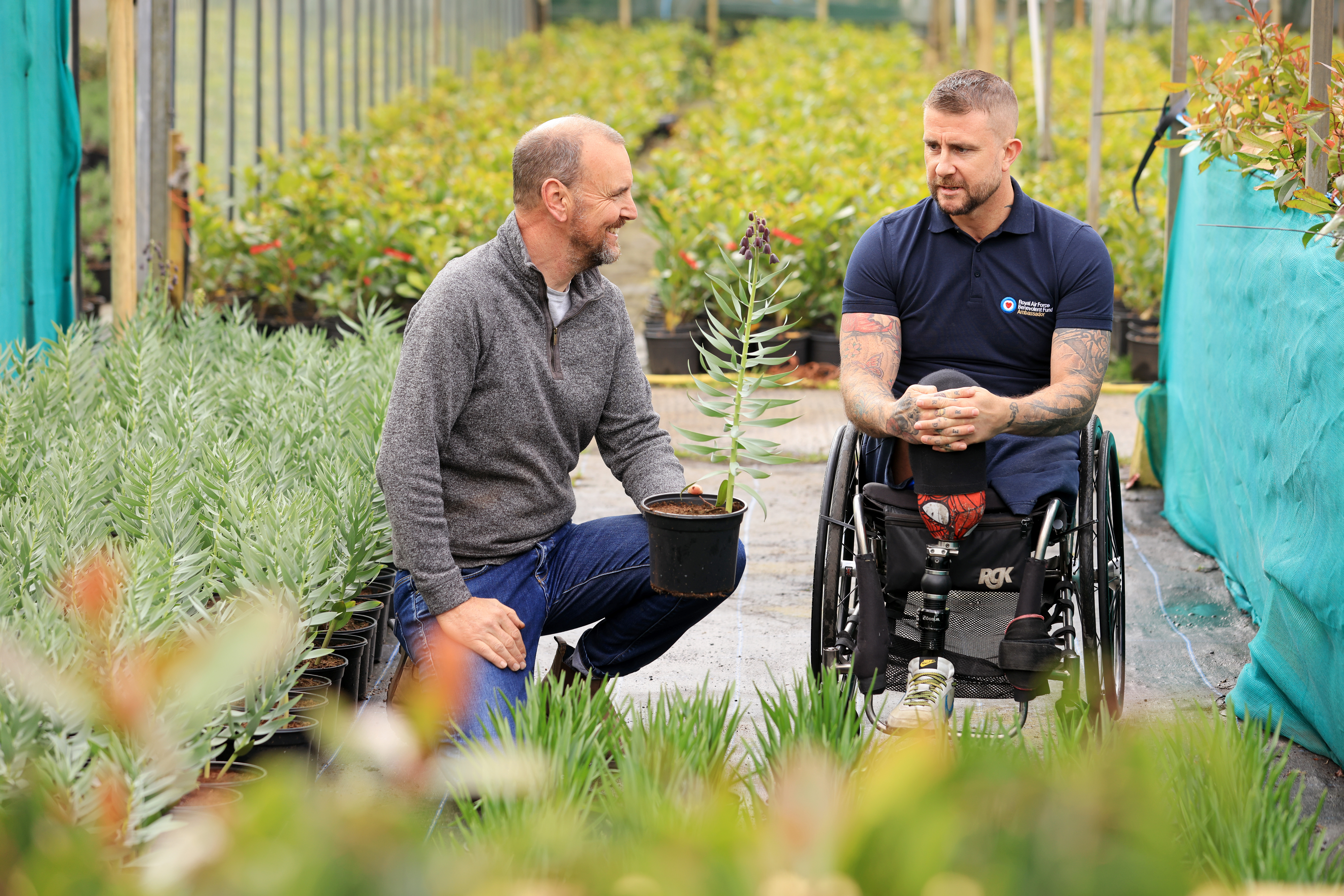 Wheelchair user in garden plots.