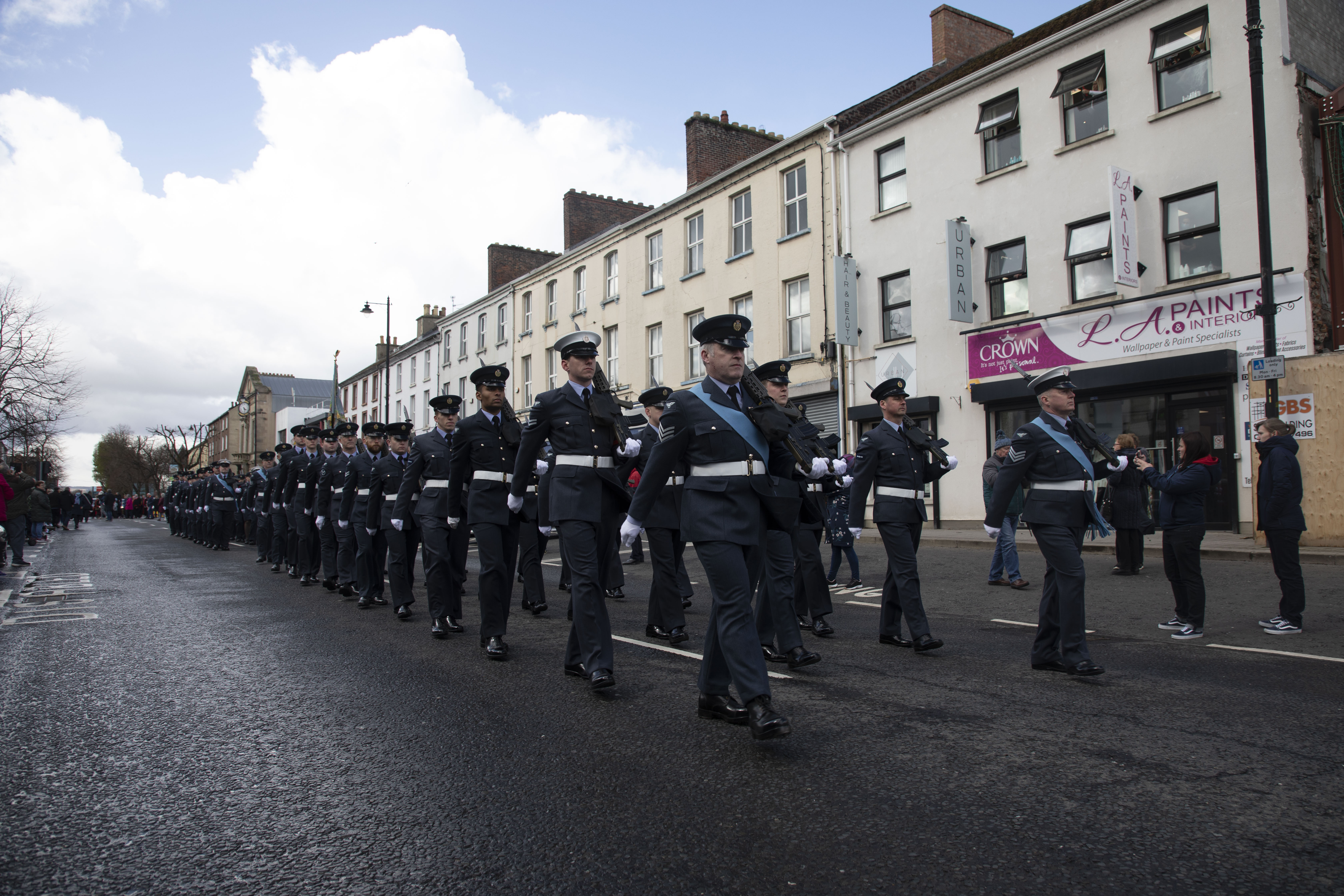Personnel parade through streets.