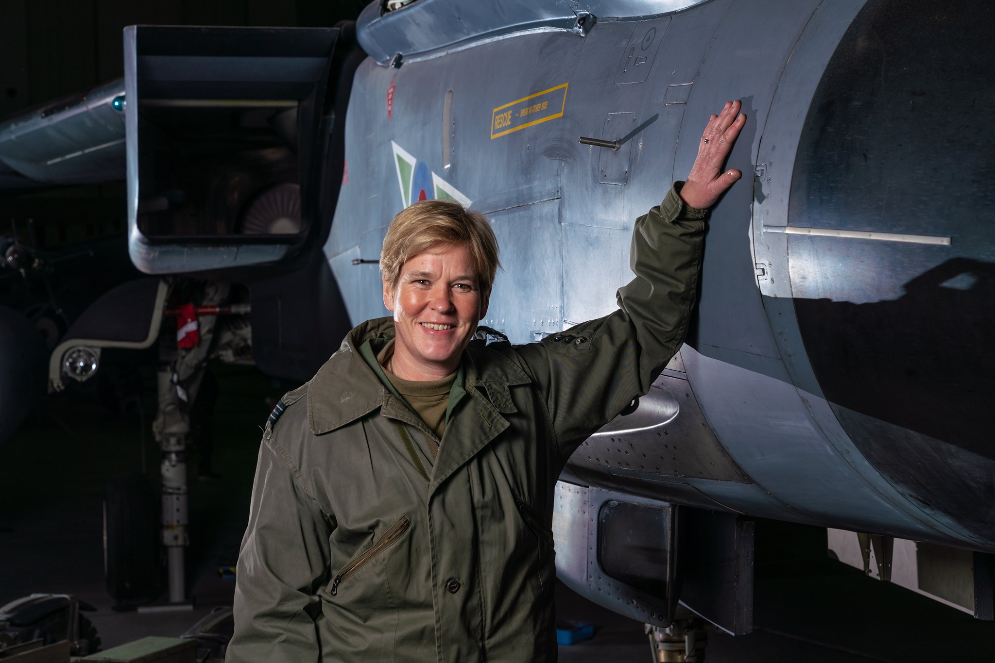Pilot leans hand against Tornado aircraft.