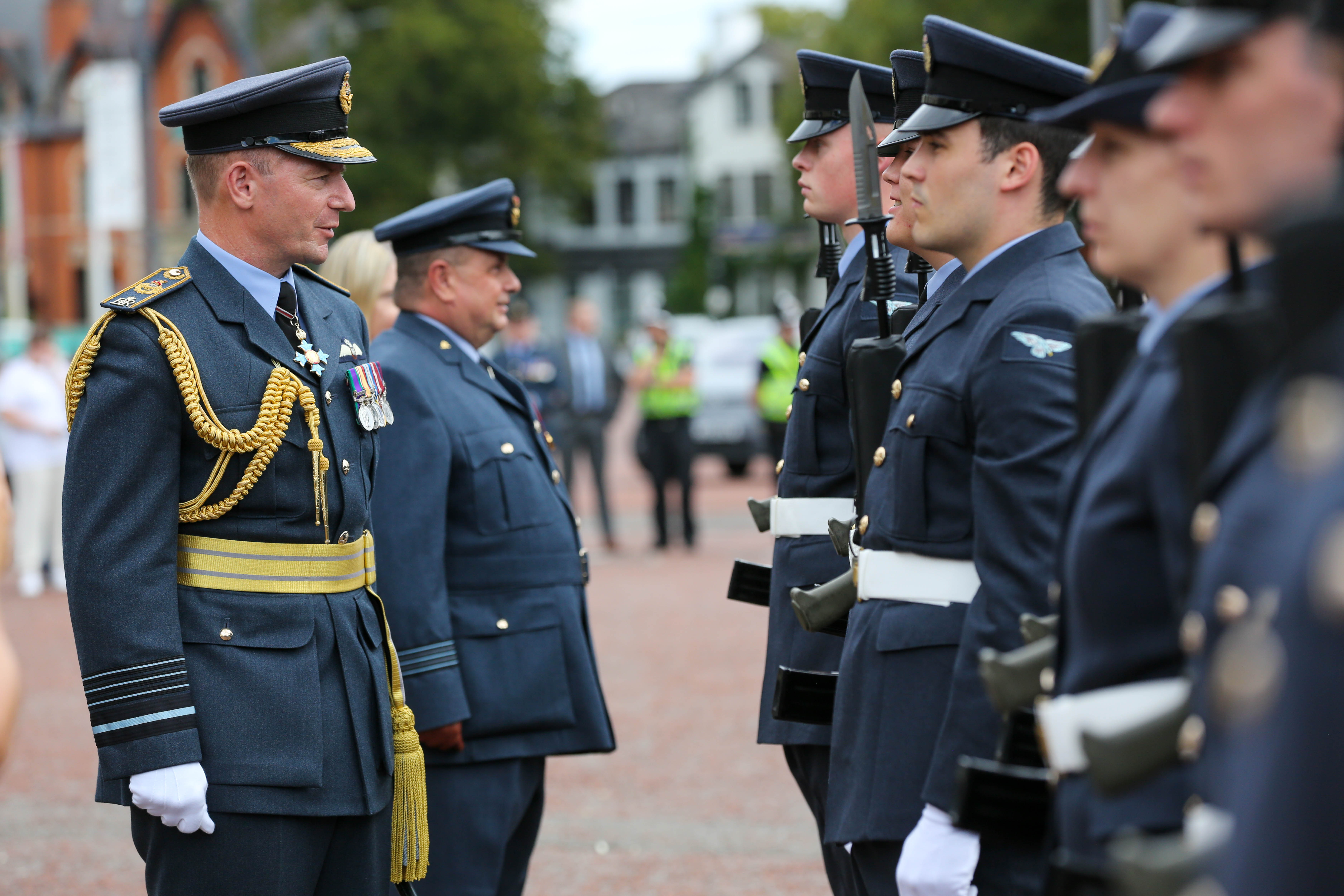 Air Chief Marshal Sir Mike Wigston talks to personnel in line at parade.