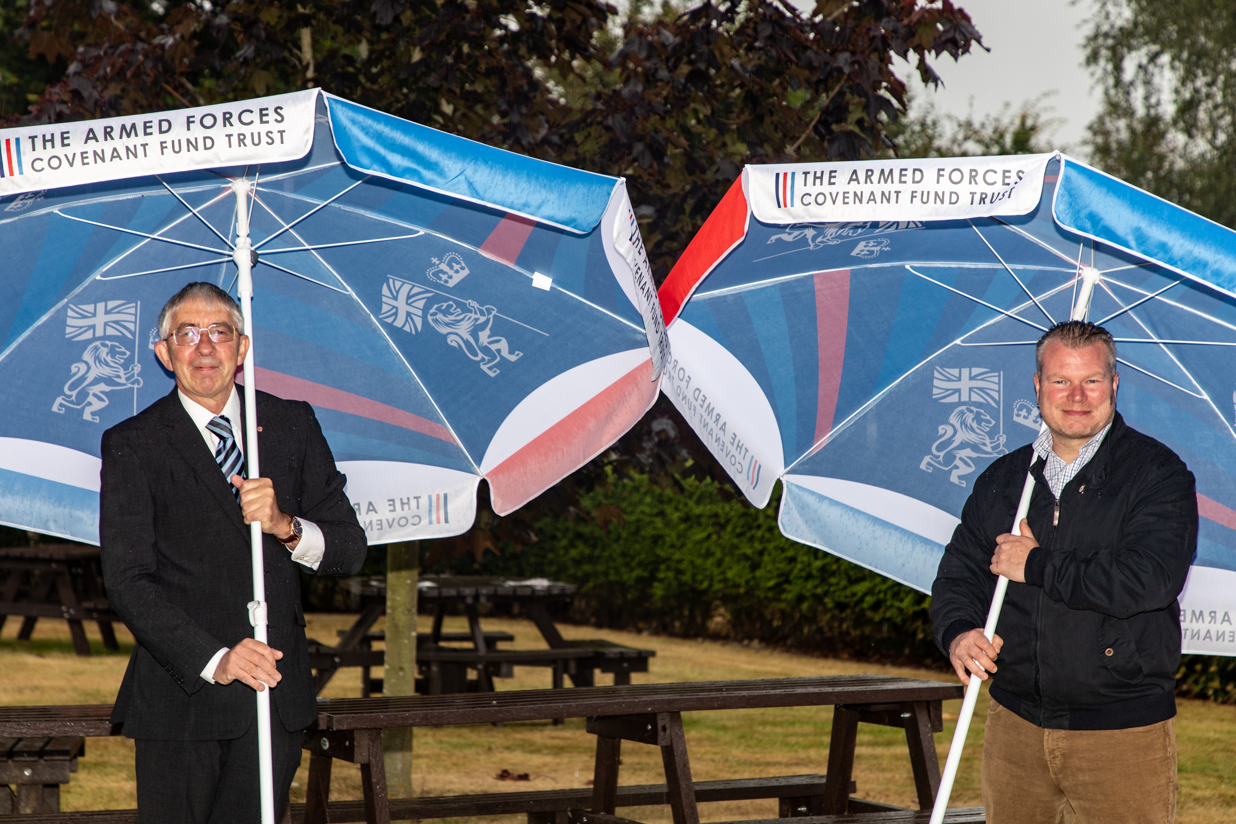 Mark Davis MBE and Thomas Kelly with the benches and parasols supplied by the Armed Forces Covenant Fund Trust