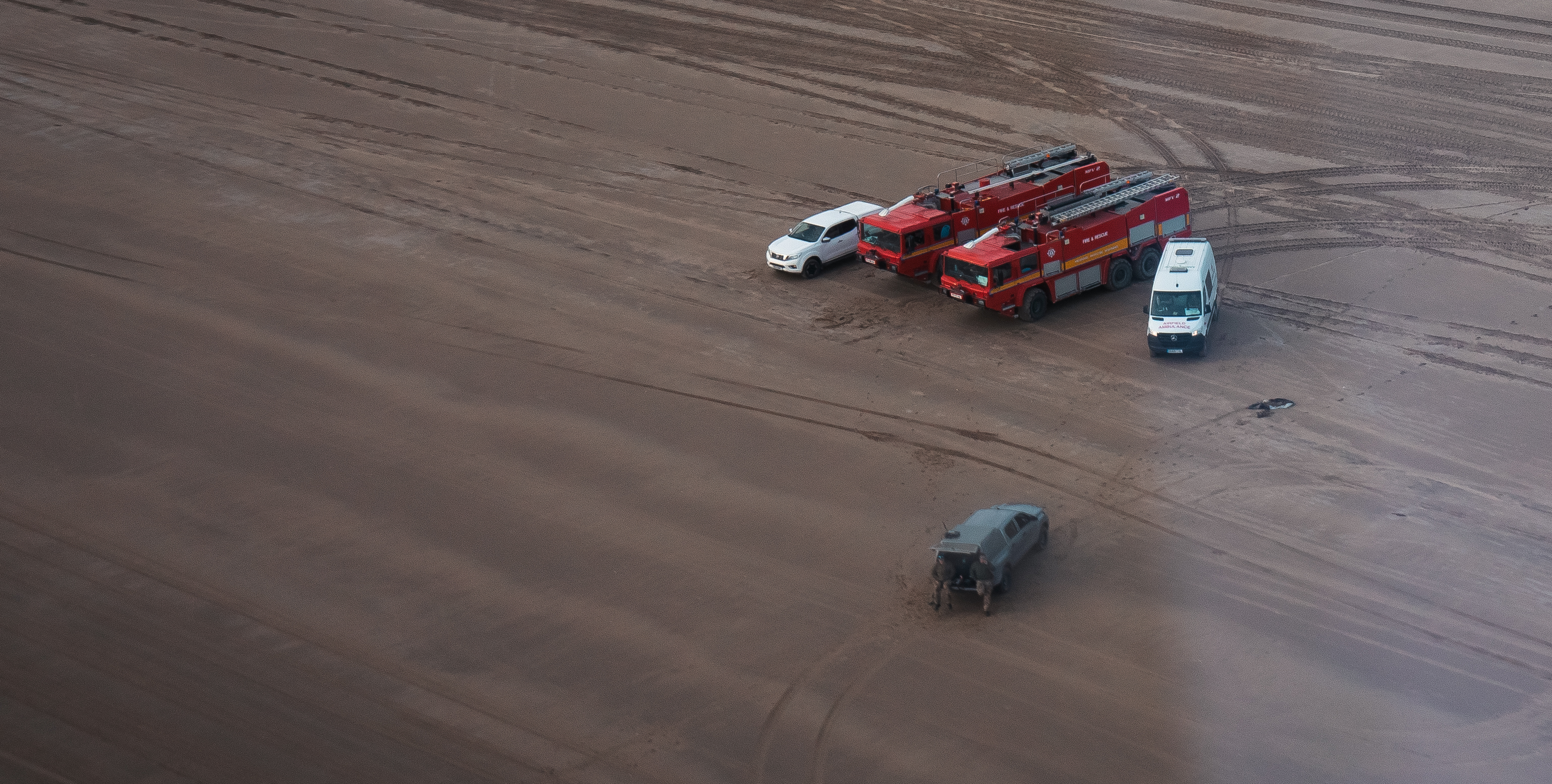 Image shows Firefighter vehicles on the beach.