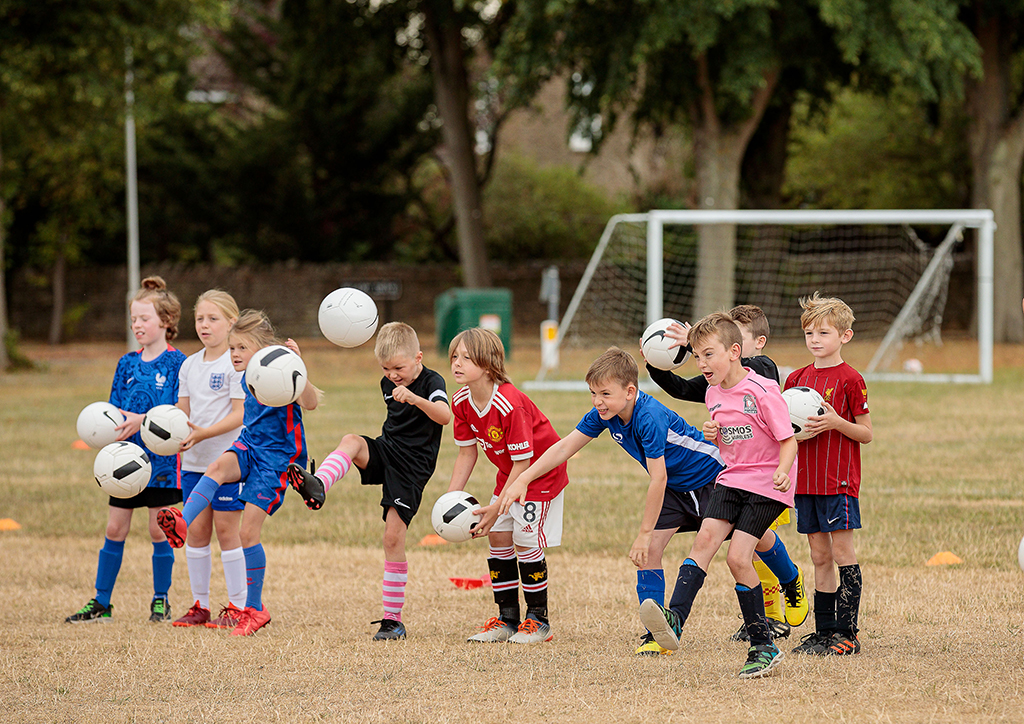 Football Academy Warming-up with Footballs - Children and young people of personnel at RAF Brize Norton benefitted from a huge range of events organised by Community Support, Airplay and RAFA Kidz this summer.
