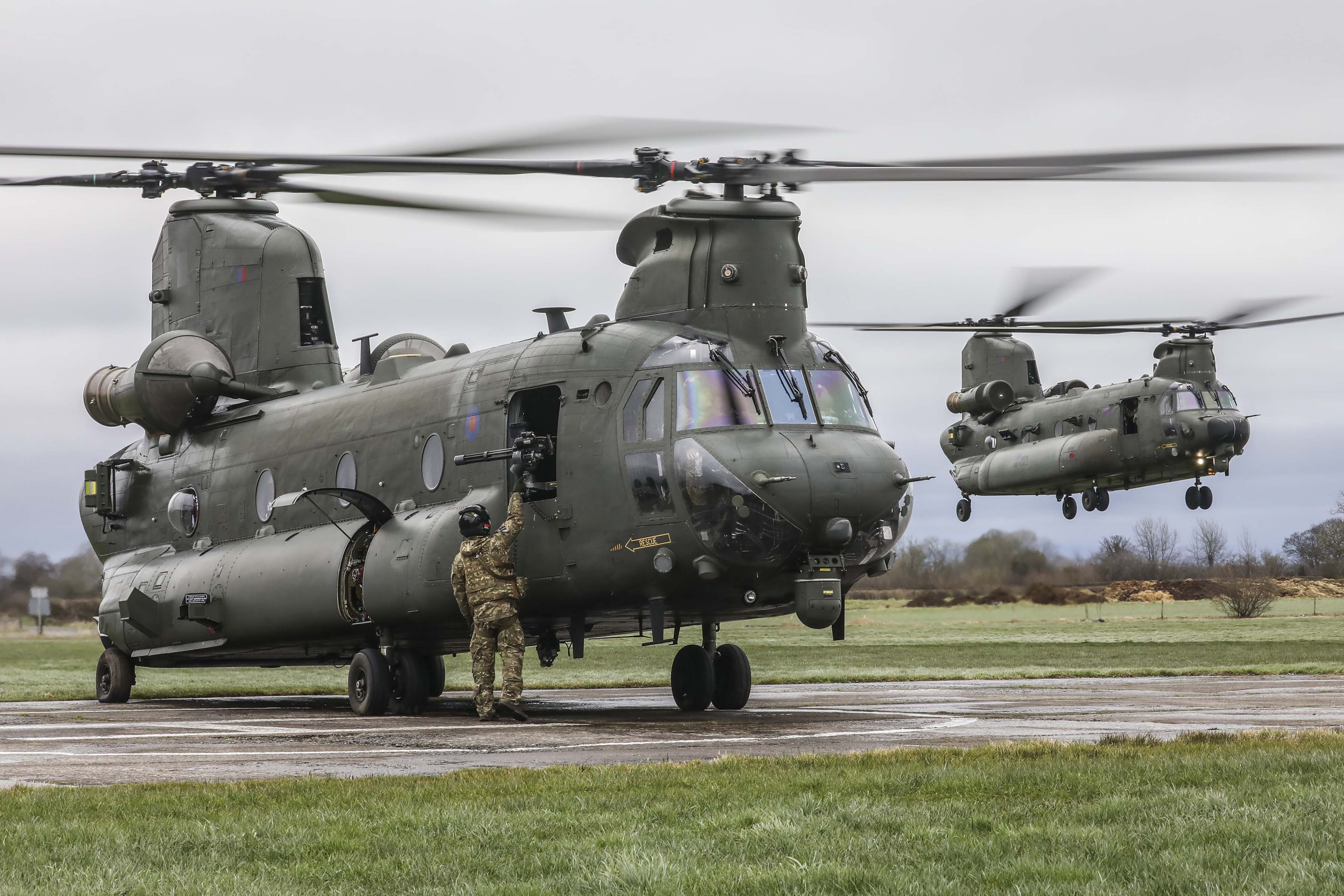Image shows Chinook helicopters coming into land on the airfield.
