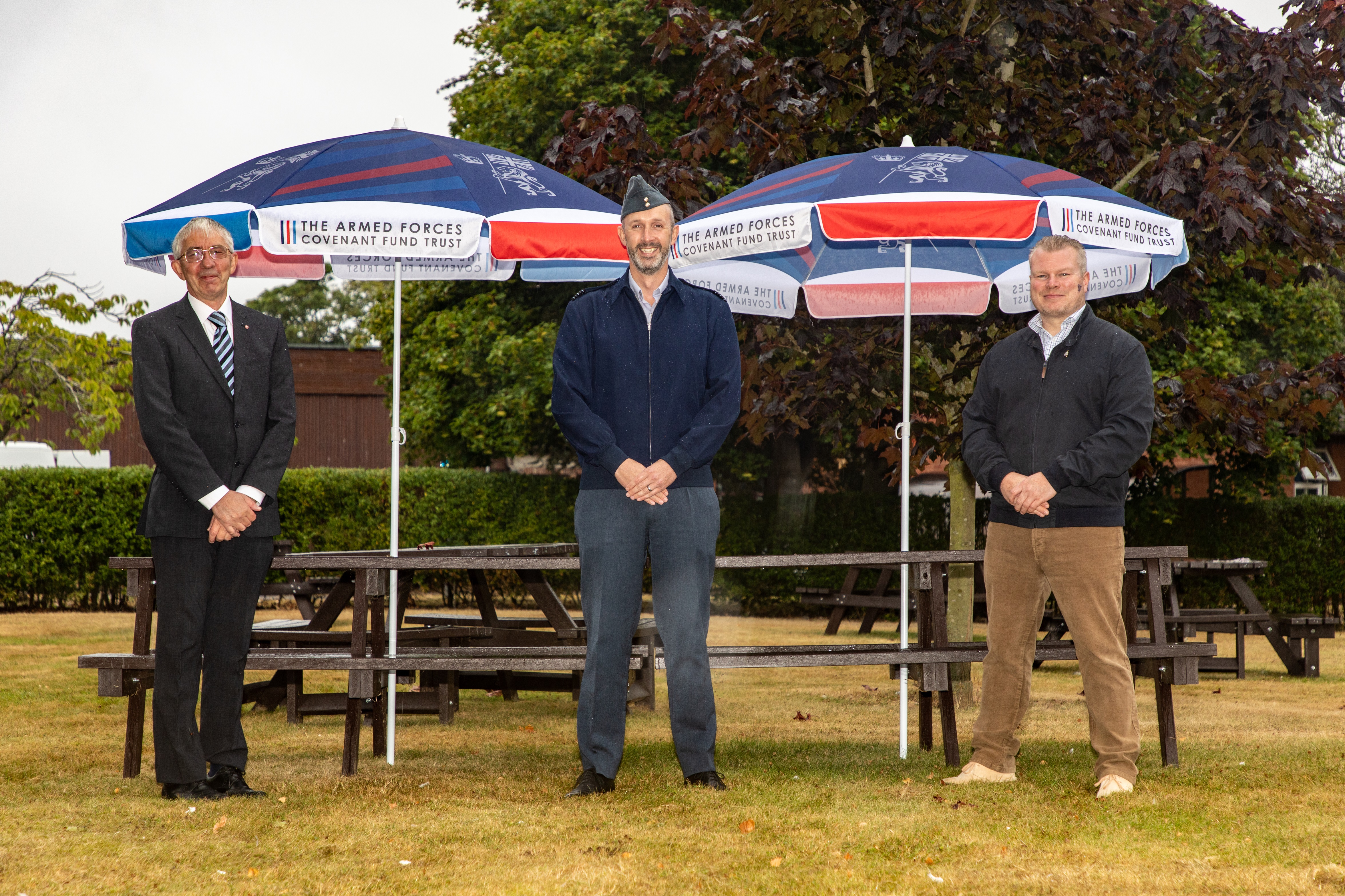 From left to right: Mark Davis MBE, Wing Commander Jez Case and Thomas Kelly with the benches and parasols supplied by the Armed Forces Covenant Fund Trust