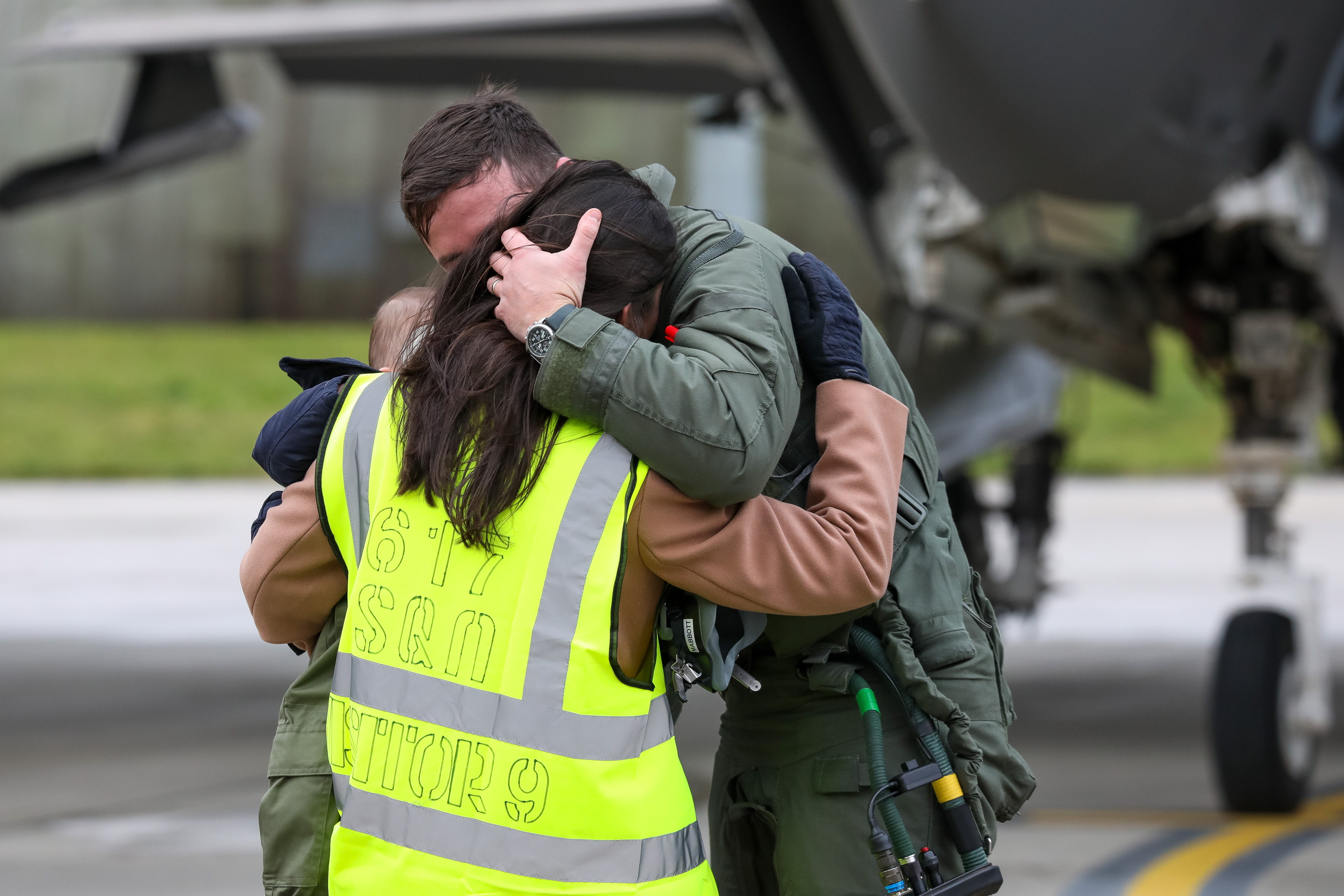 Pilot hugs family. 