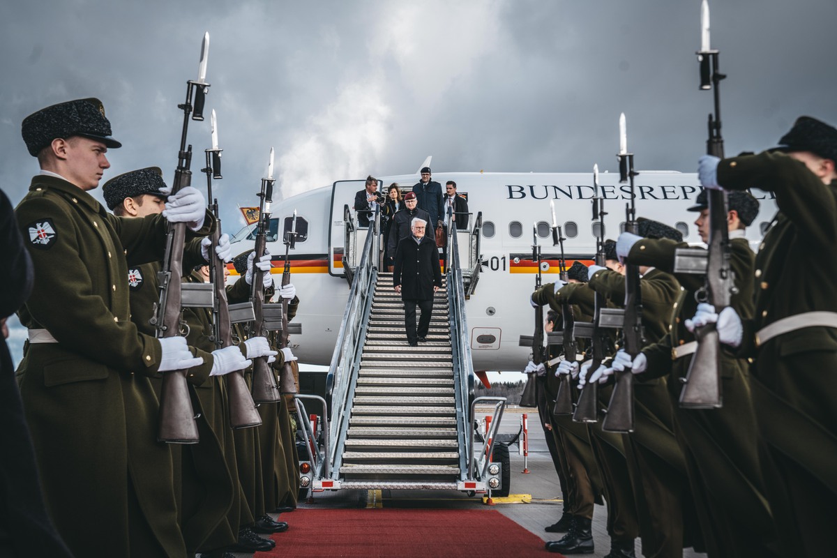 Image shows RAF and German personnel with rifles lined up ready for the German President as he leaves his transport aircraft on the airfield. 