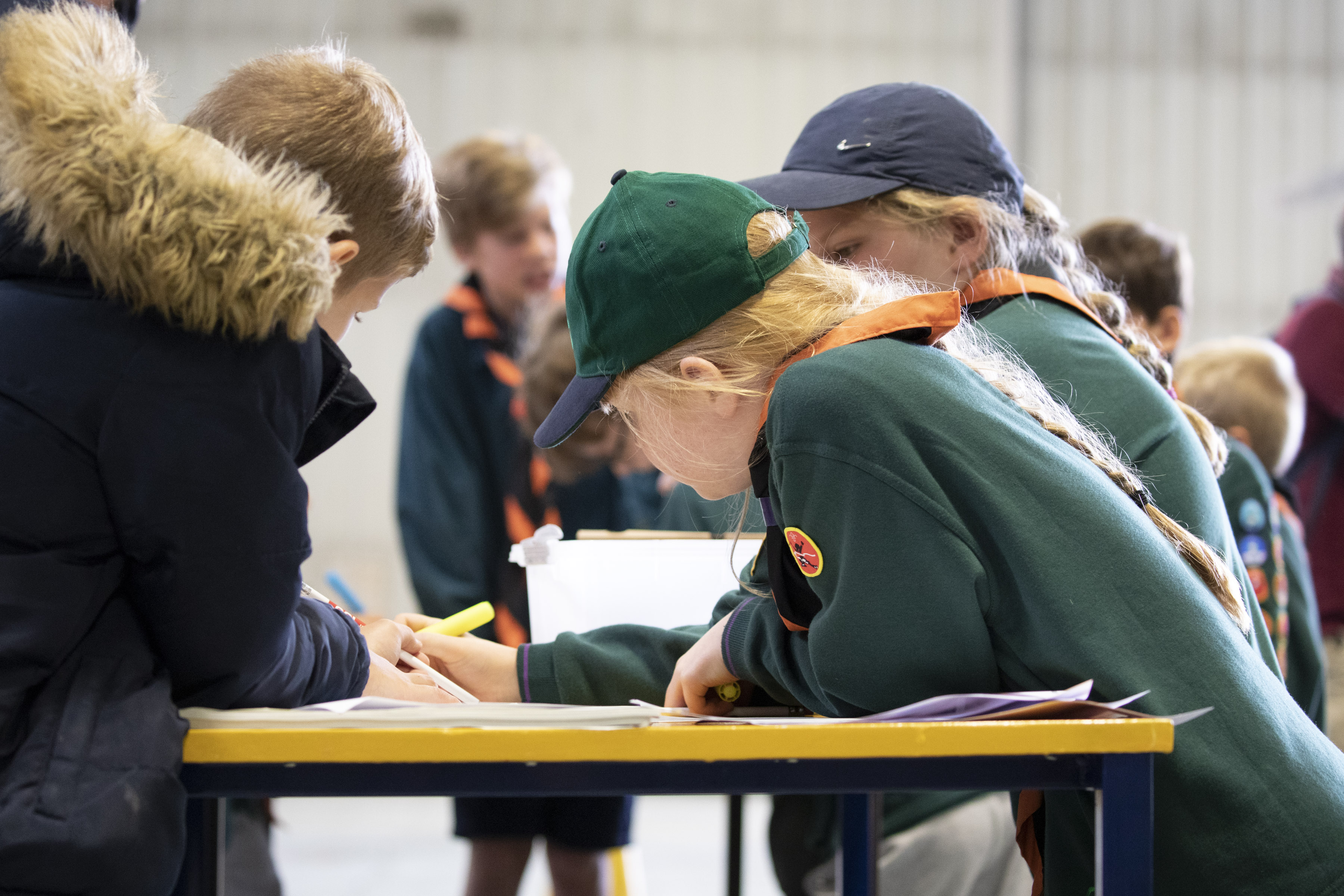 School children work on a table.
