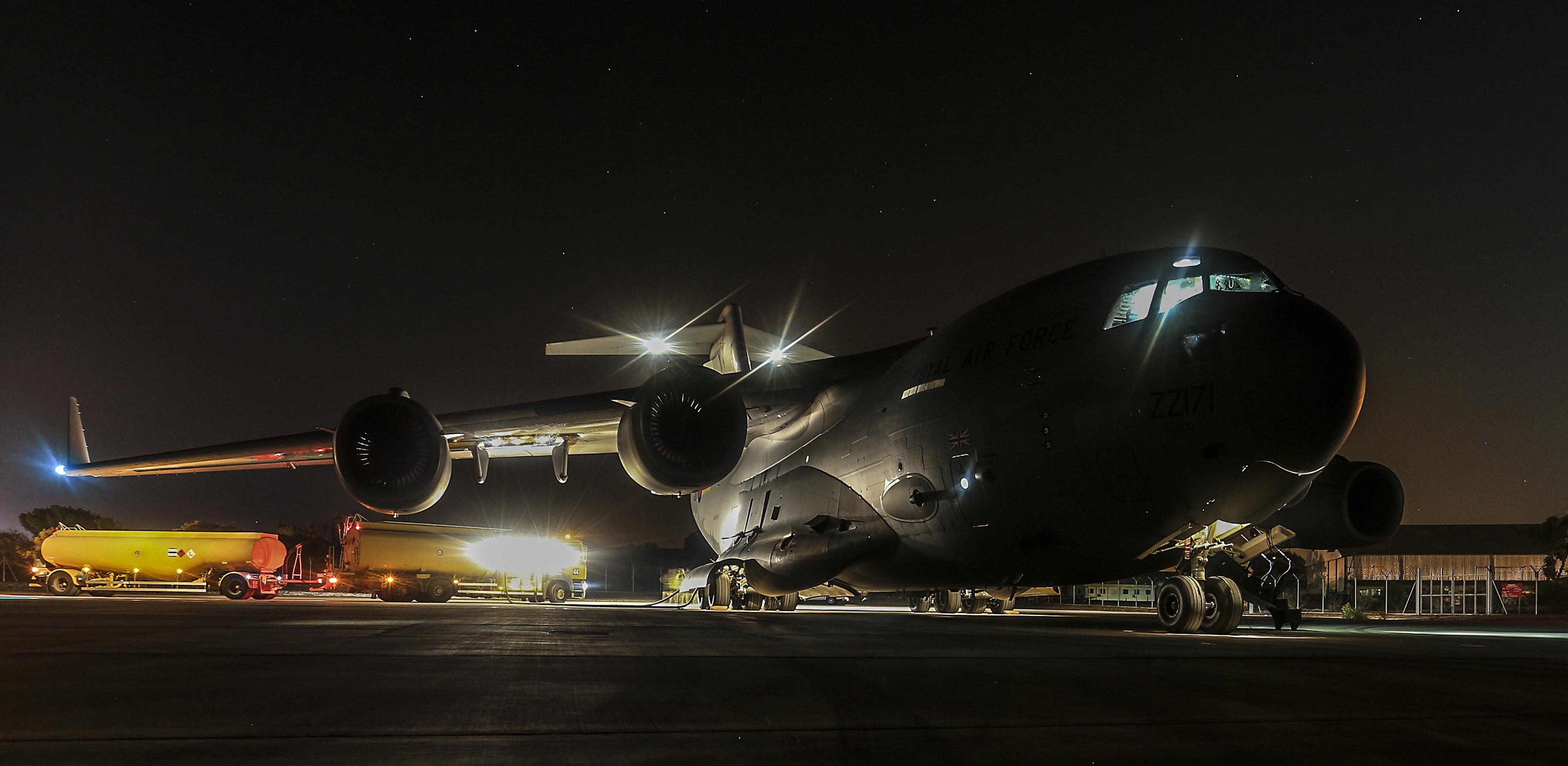 An RAF C17 Globemaster prepares to take off at night