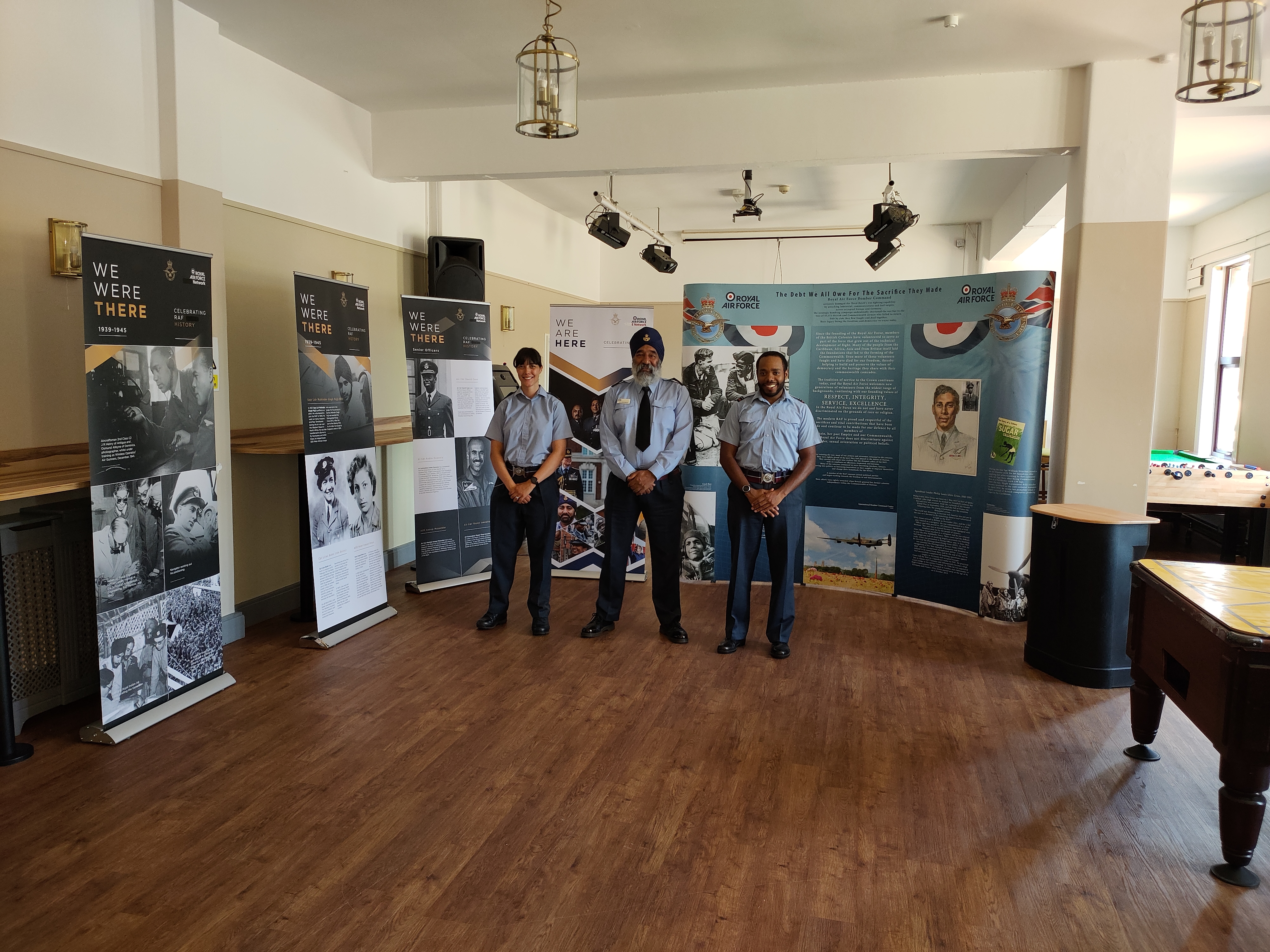 Aviators stand in presentation room.