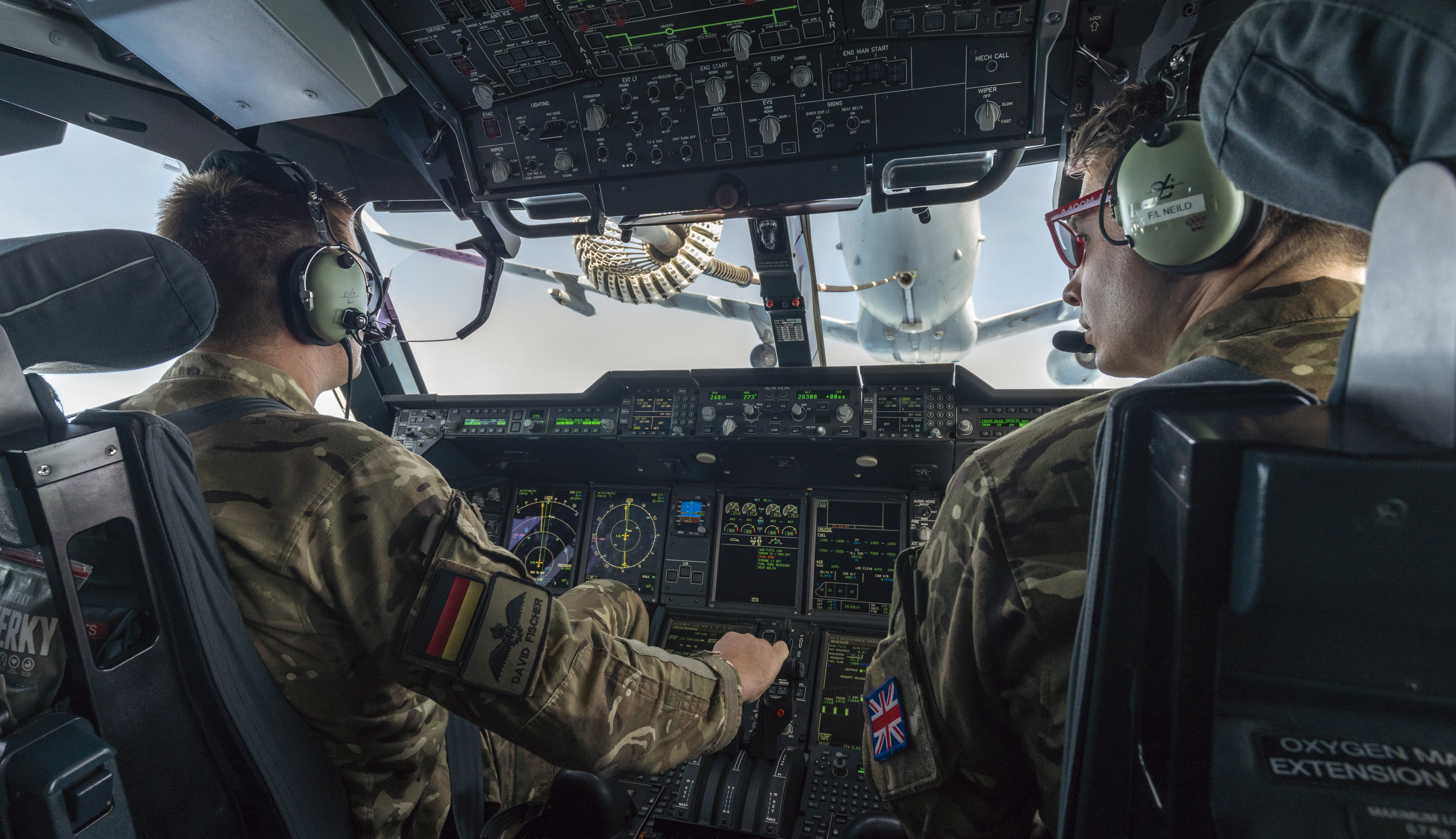 View from inside RAF Atlas cockpit as it is being refuelled by a RAF Voyager. German pilot and UK pilot. 