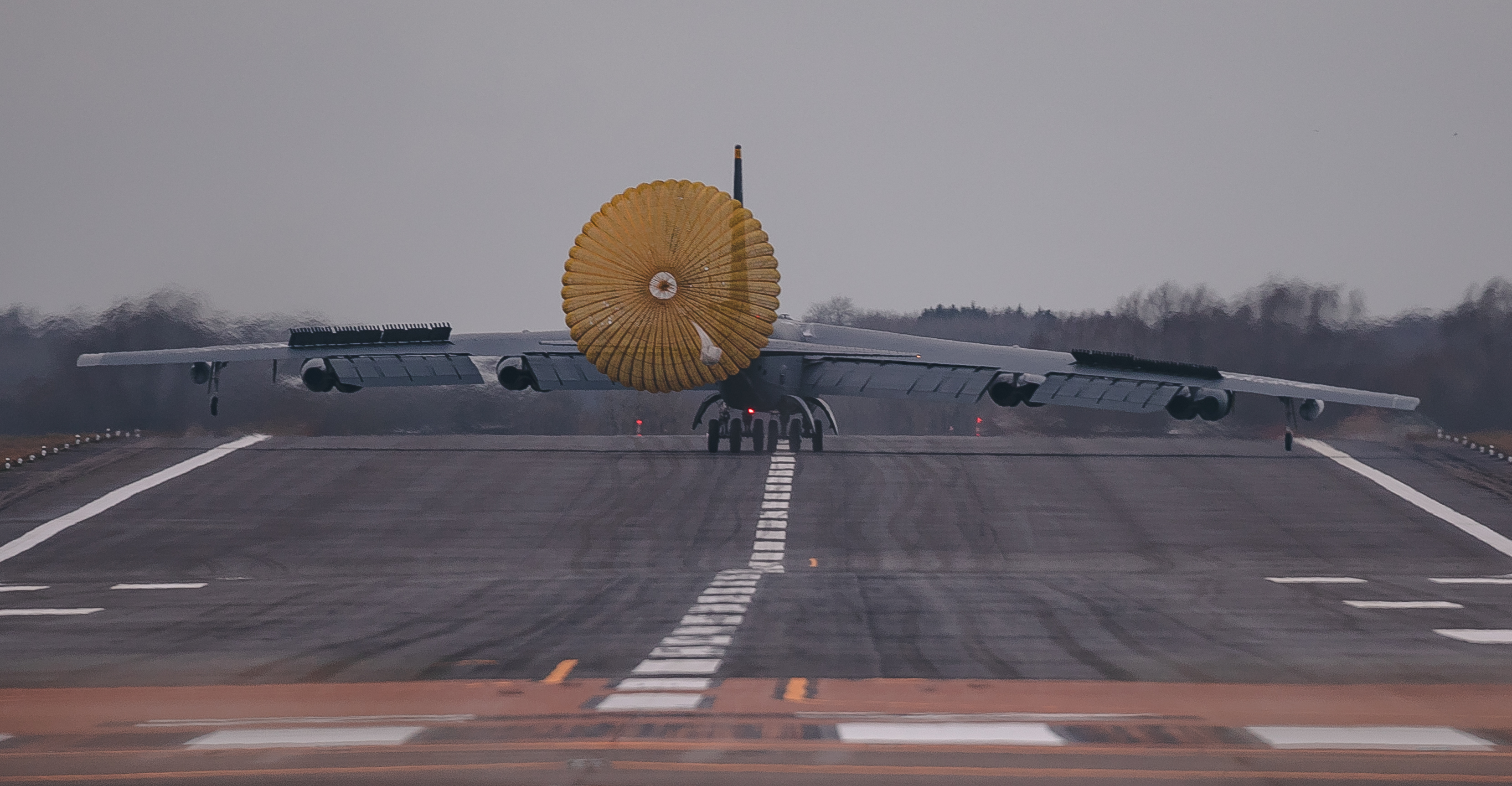 US B-52 on the runway with parachute to slow down.