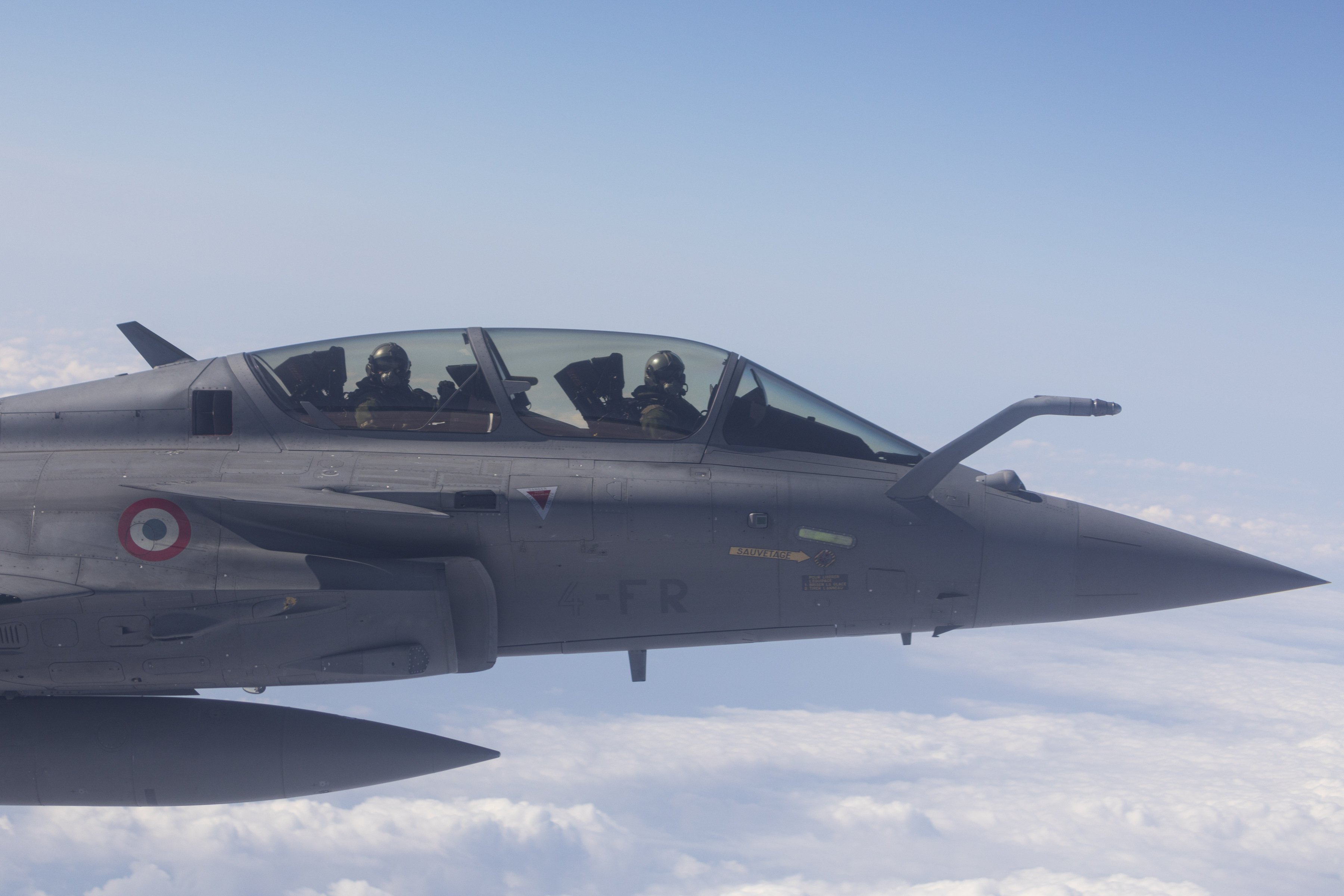 Close up of. Pilot and French aircraft in flight.