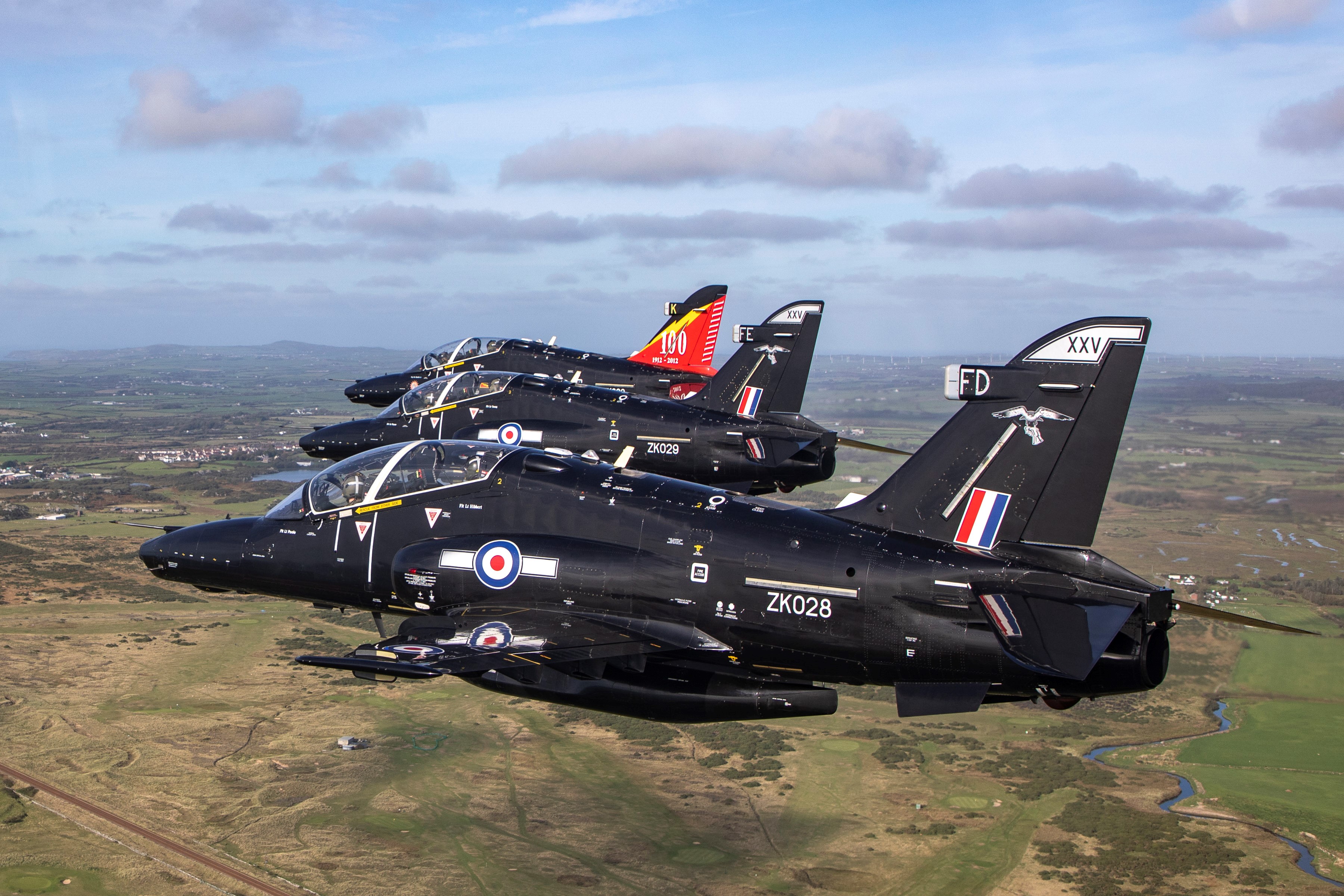 Three Hawk T2 aircraft flying in formation.