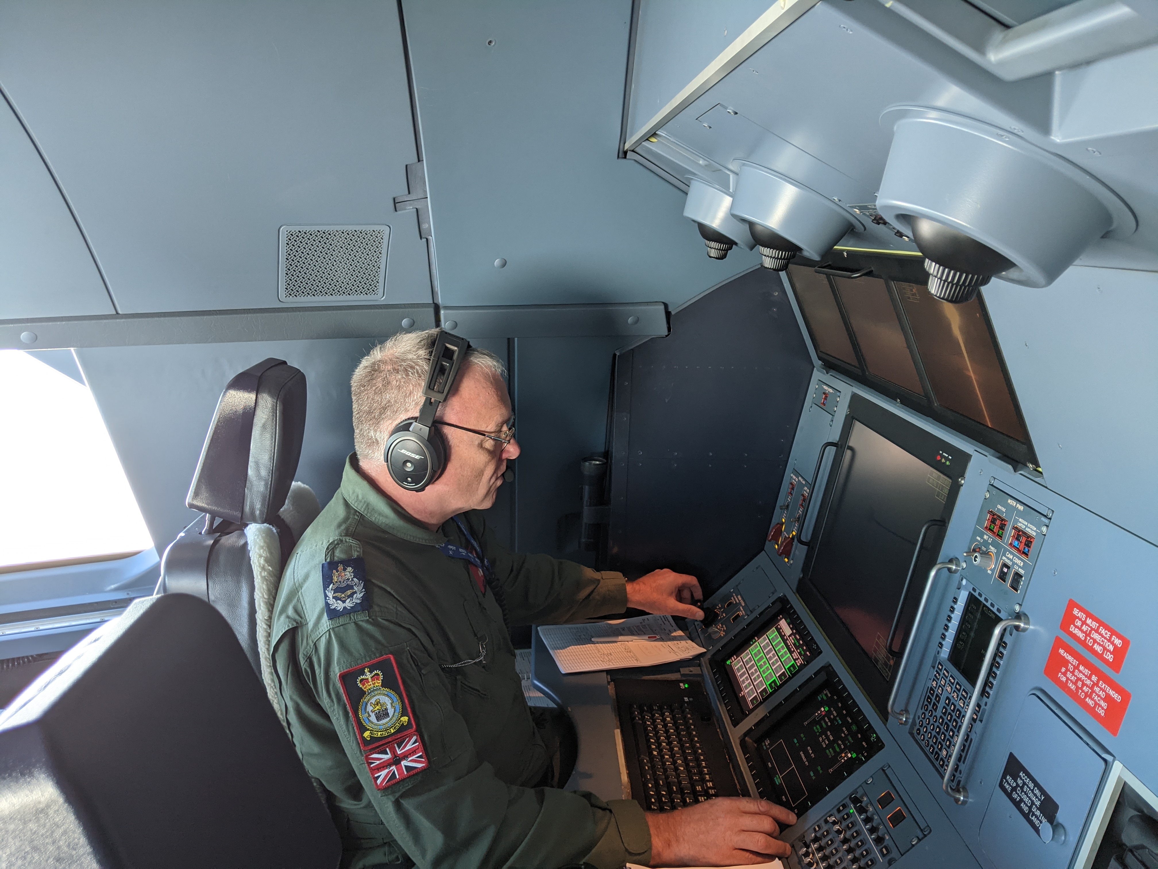 Pilot works inside the cockpit of a RAF Voyager.
