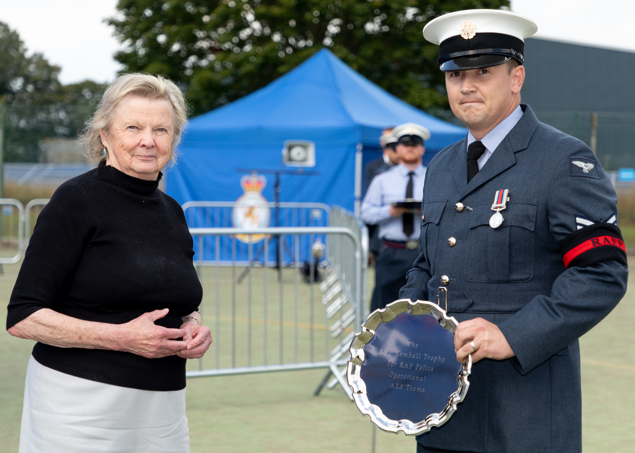 RAF Police Handler holds trophy. 