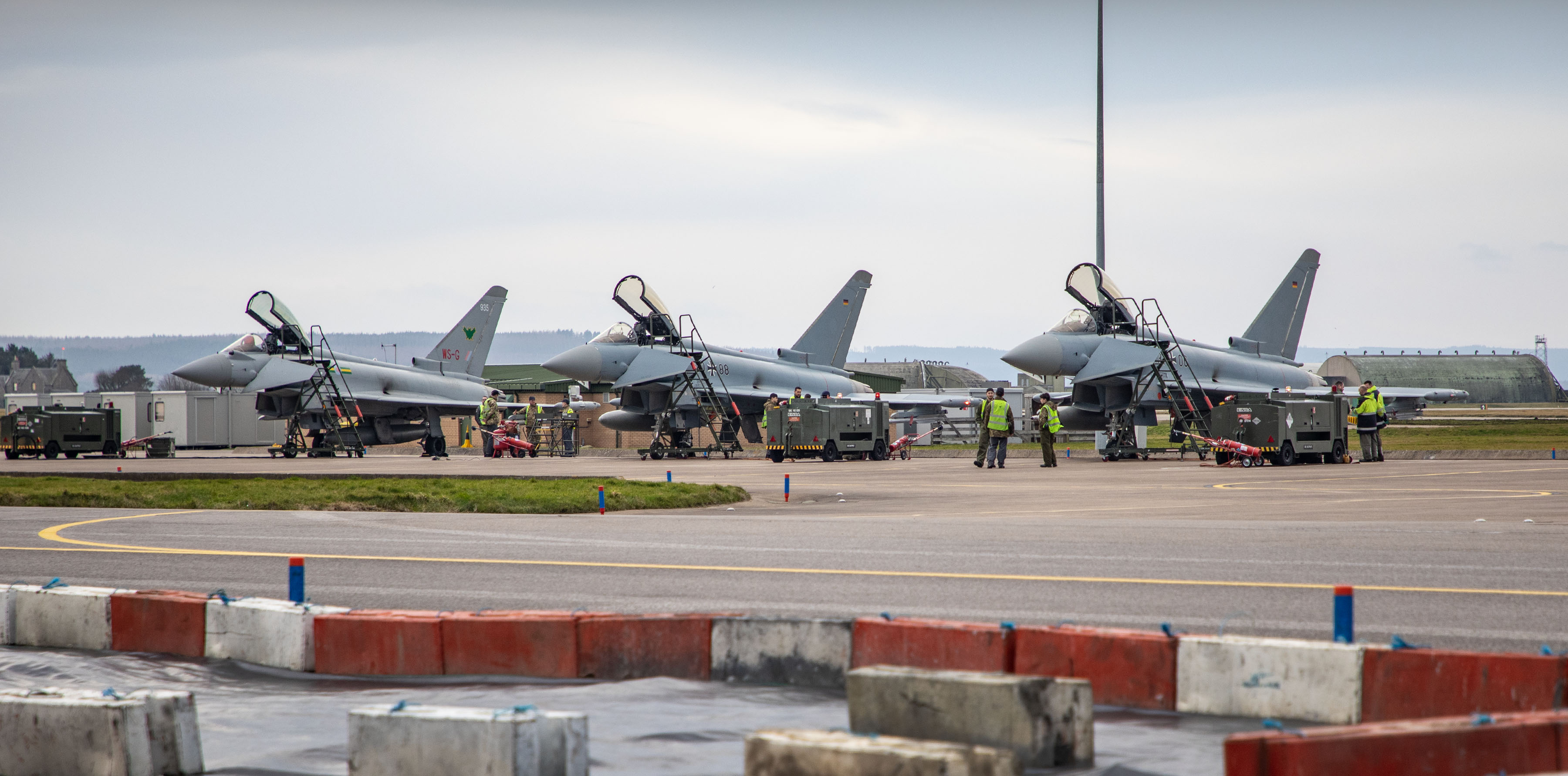 Image shows Typhoons on the airfield with the cockpits open.