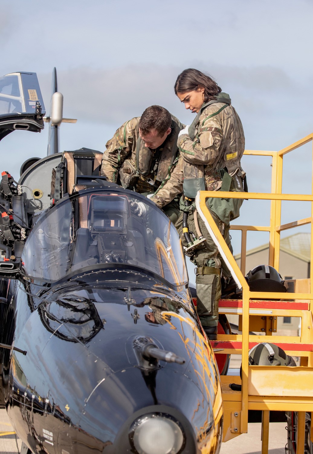 Personnel look into Hawk T2 cockpit.