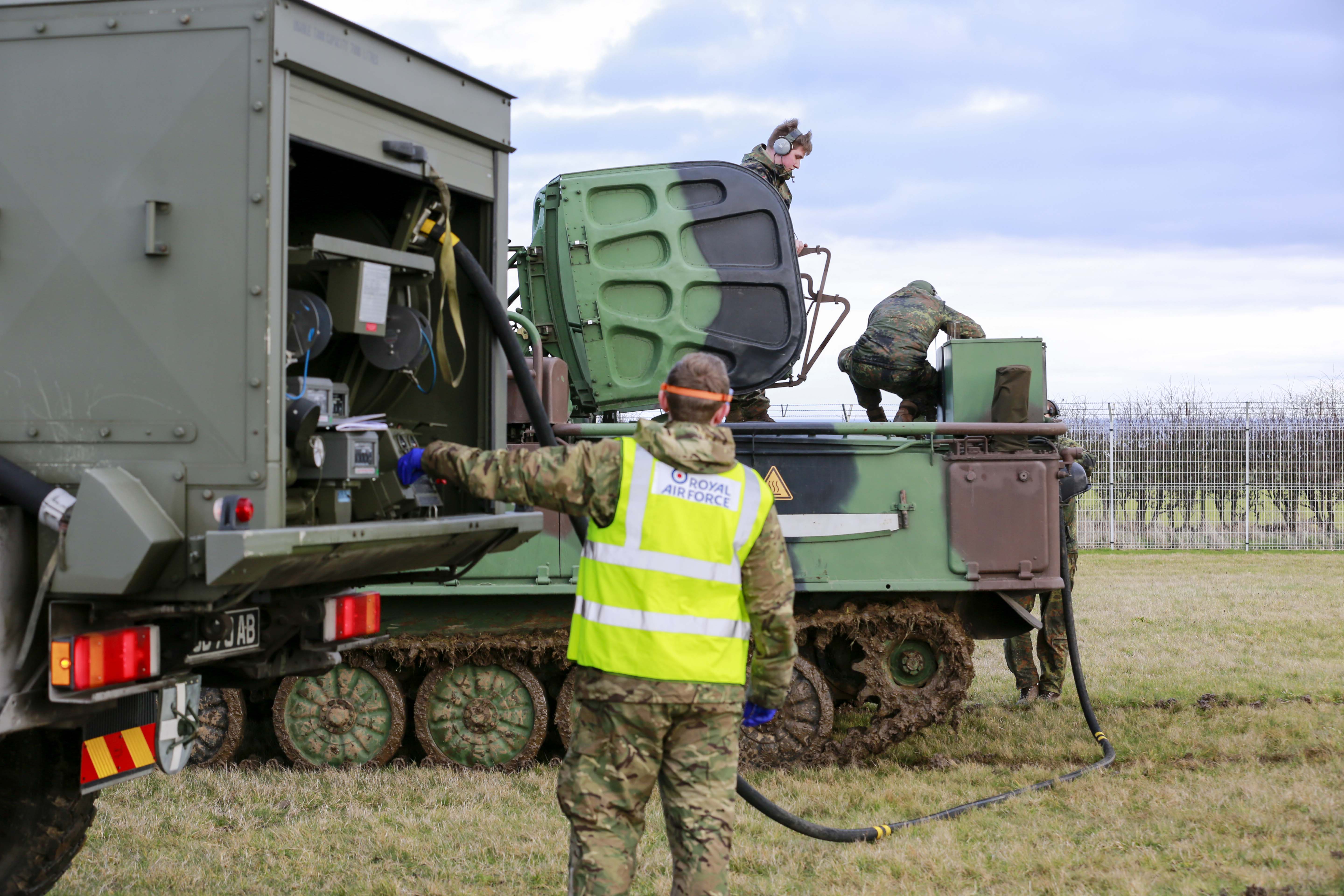 Image shows personnel refuelling heavy vehicles.