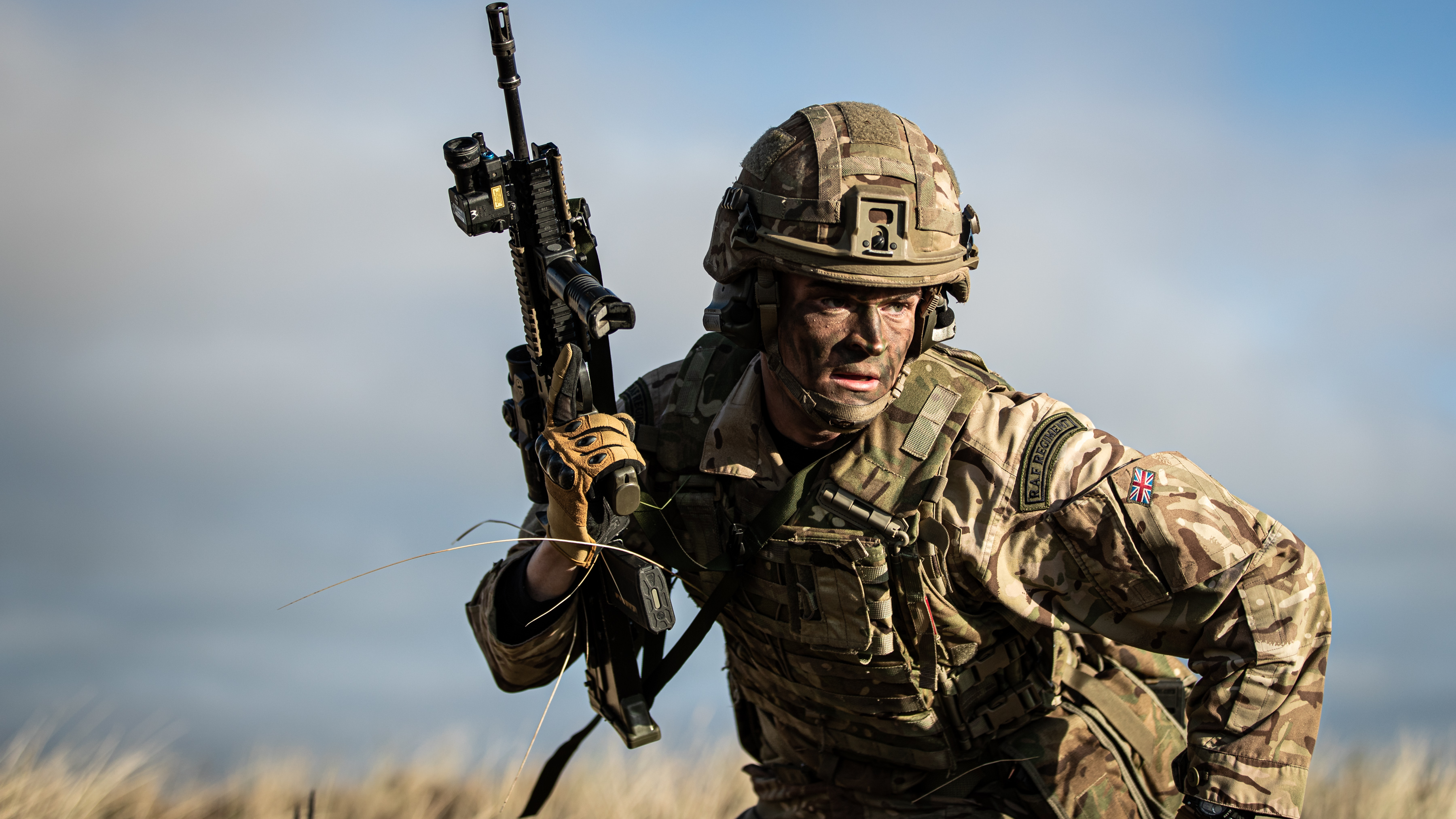 Image shows RAF Regiment holding rifle during exercise.