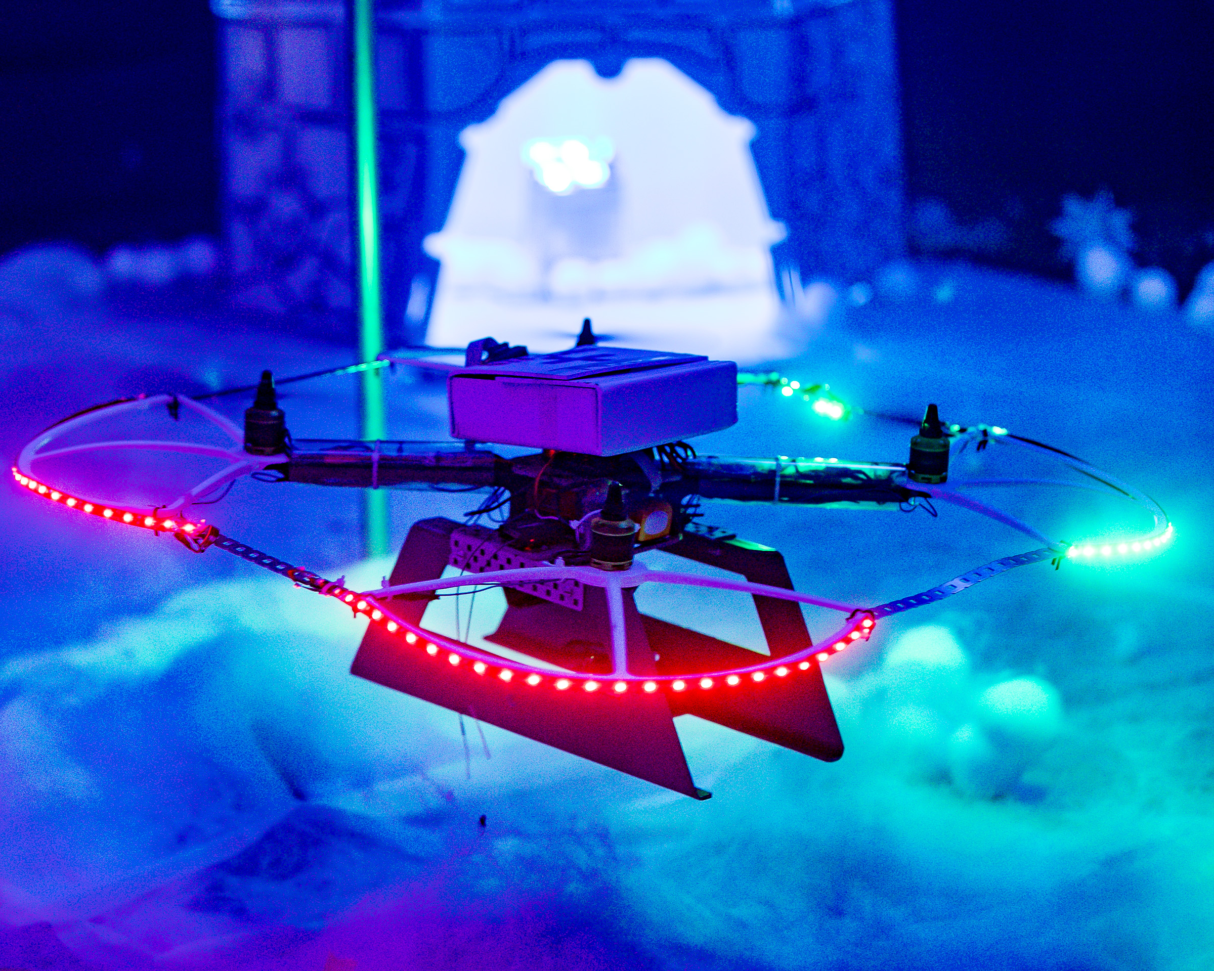 Image shows a quadcopter model with LED lights and smoke.