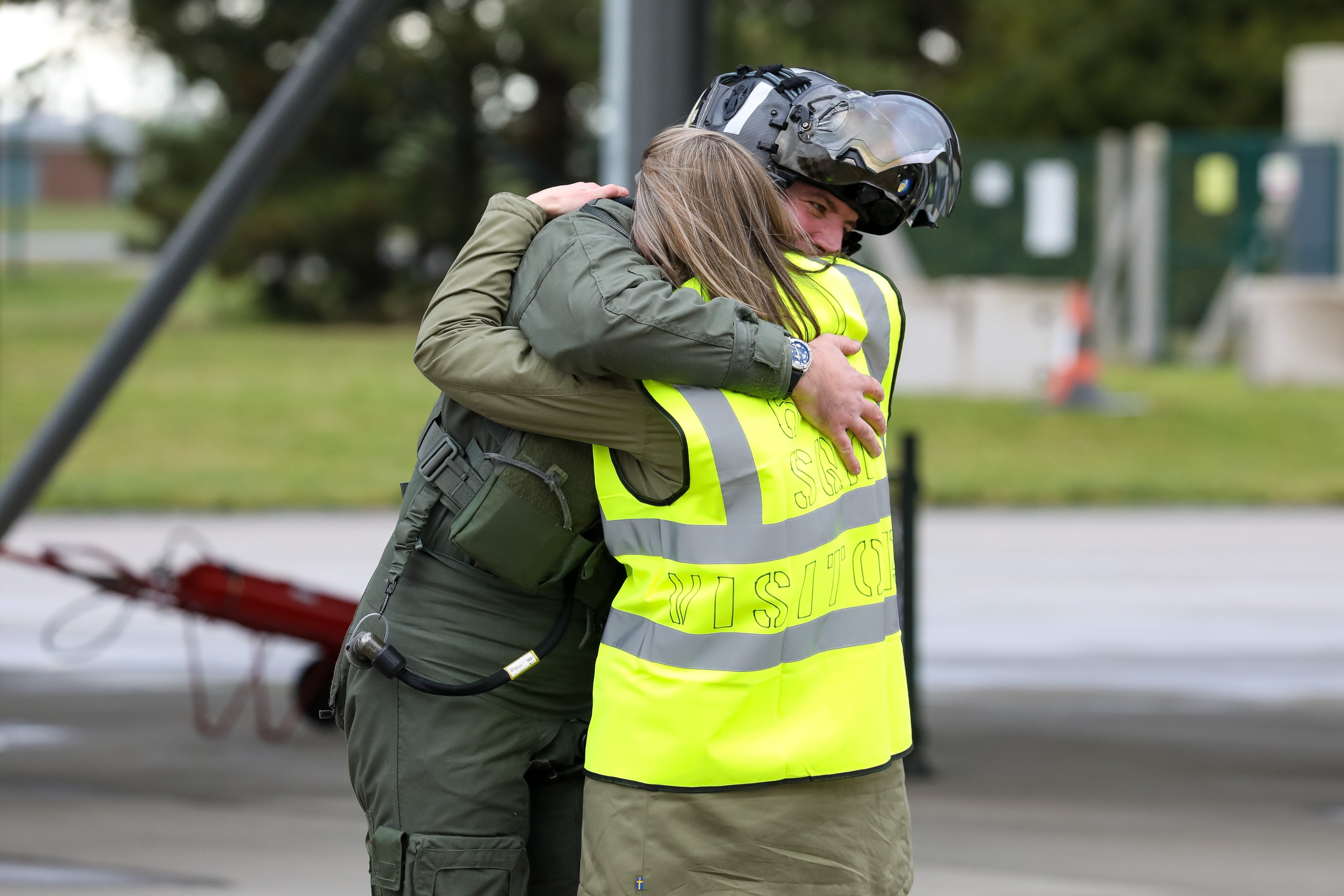 Pilot hugs family. 
