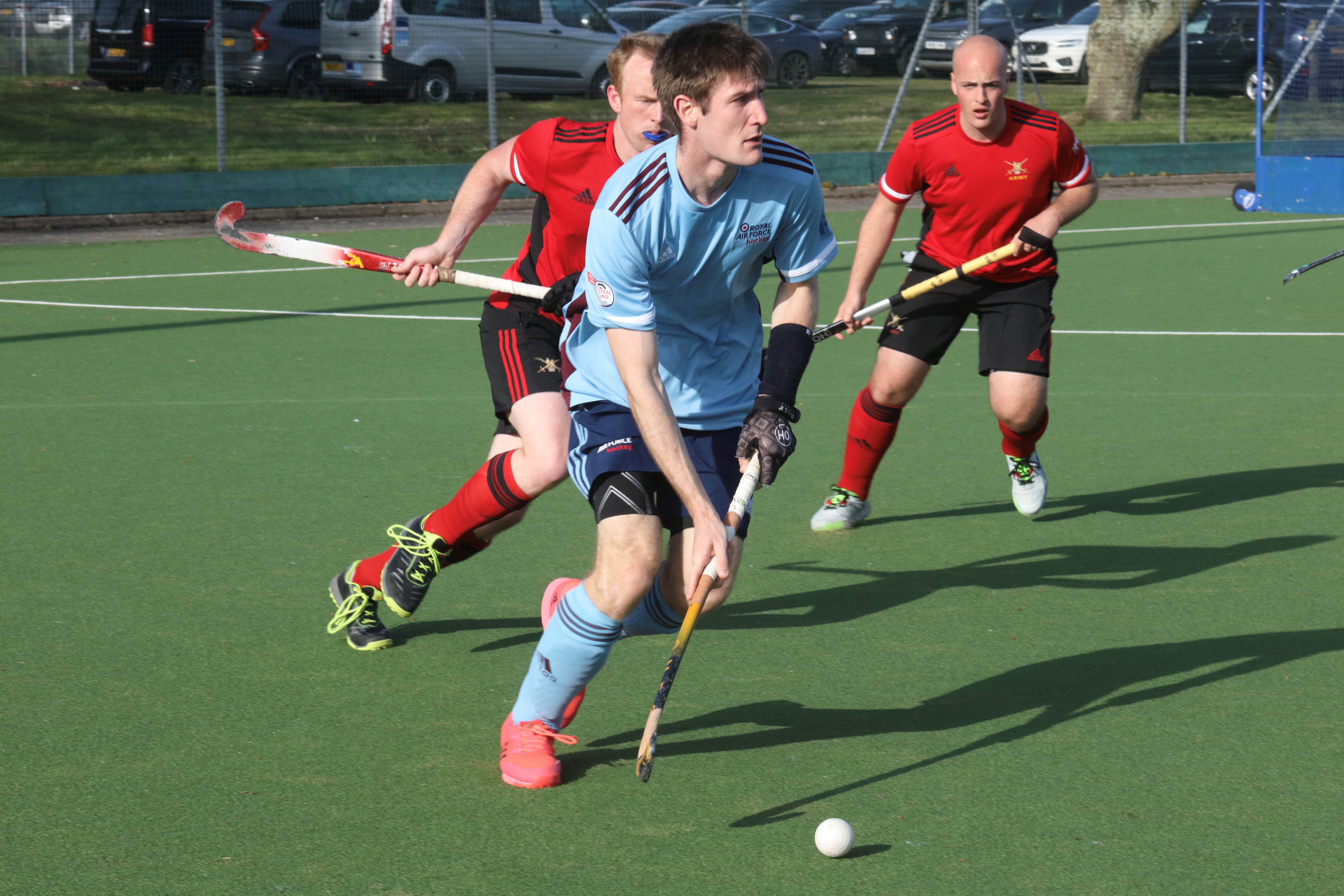 Image shows hockey players on the pitch during a game.