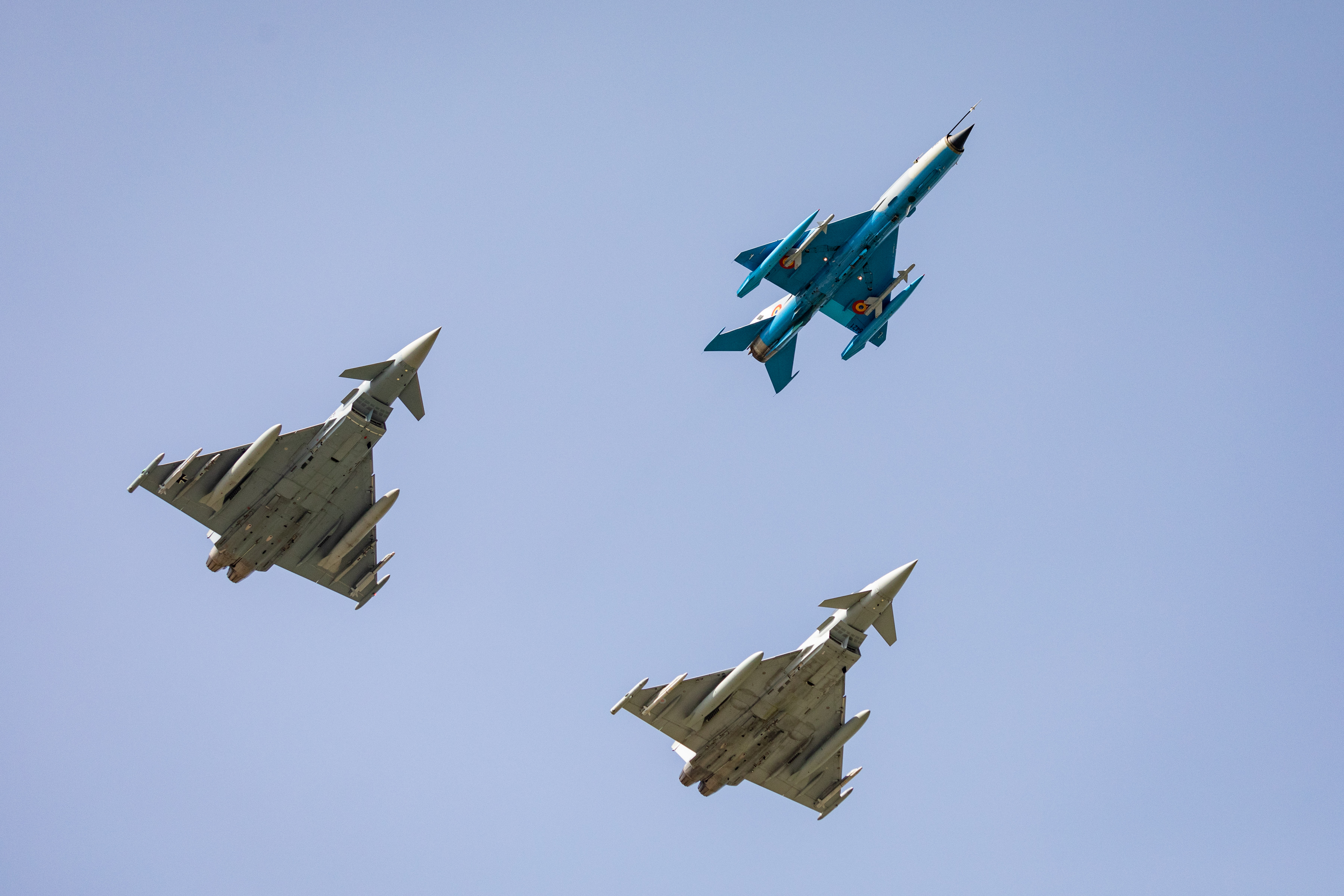 Two RAF Typhoons and a Romanian MIG 21 LanceR in formation.