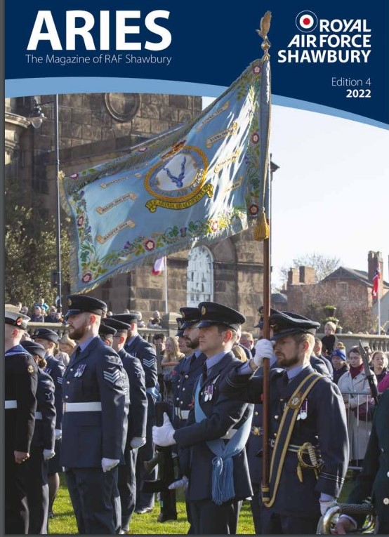 Front cover of Aries magazine, showing RAF aviators on parade with RAF Shawbury flag.