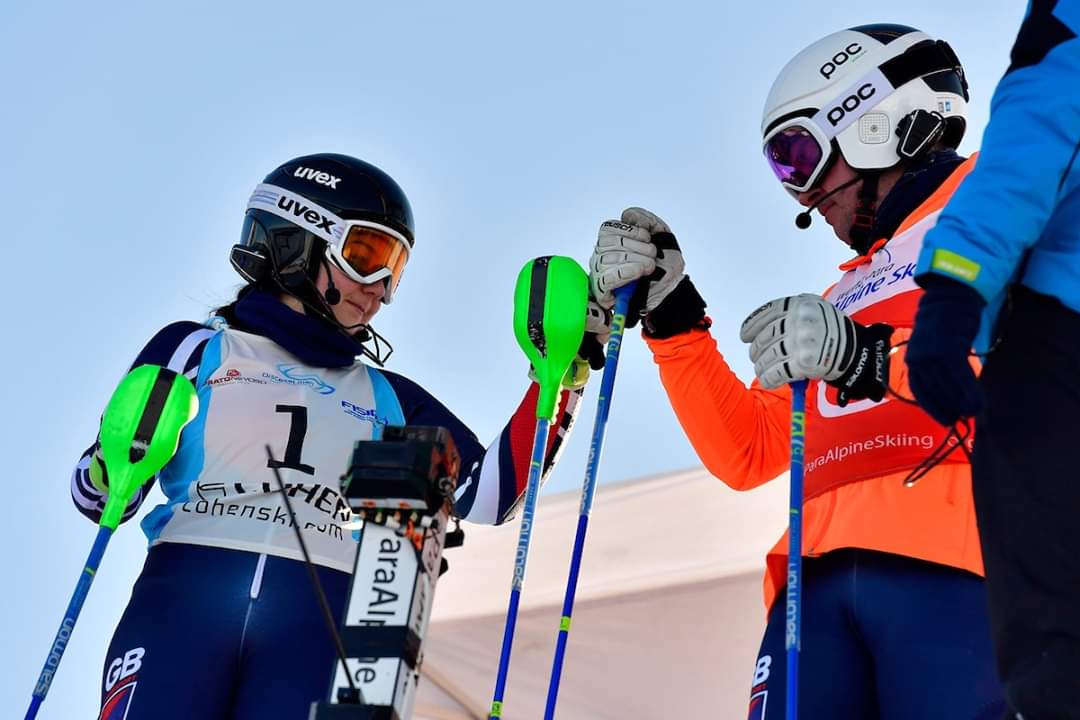 Two in skiing gear pump fists.