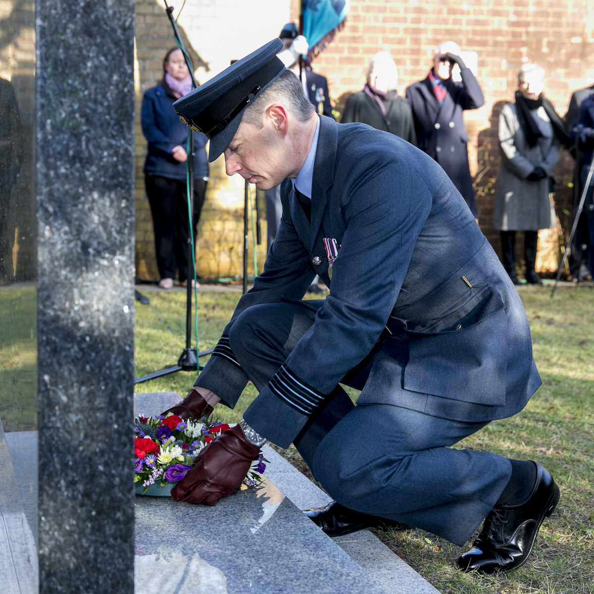 Personnel laying a wreath at the memorial.
