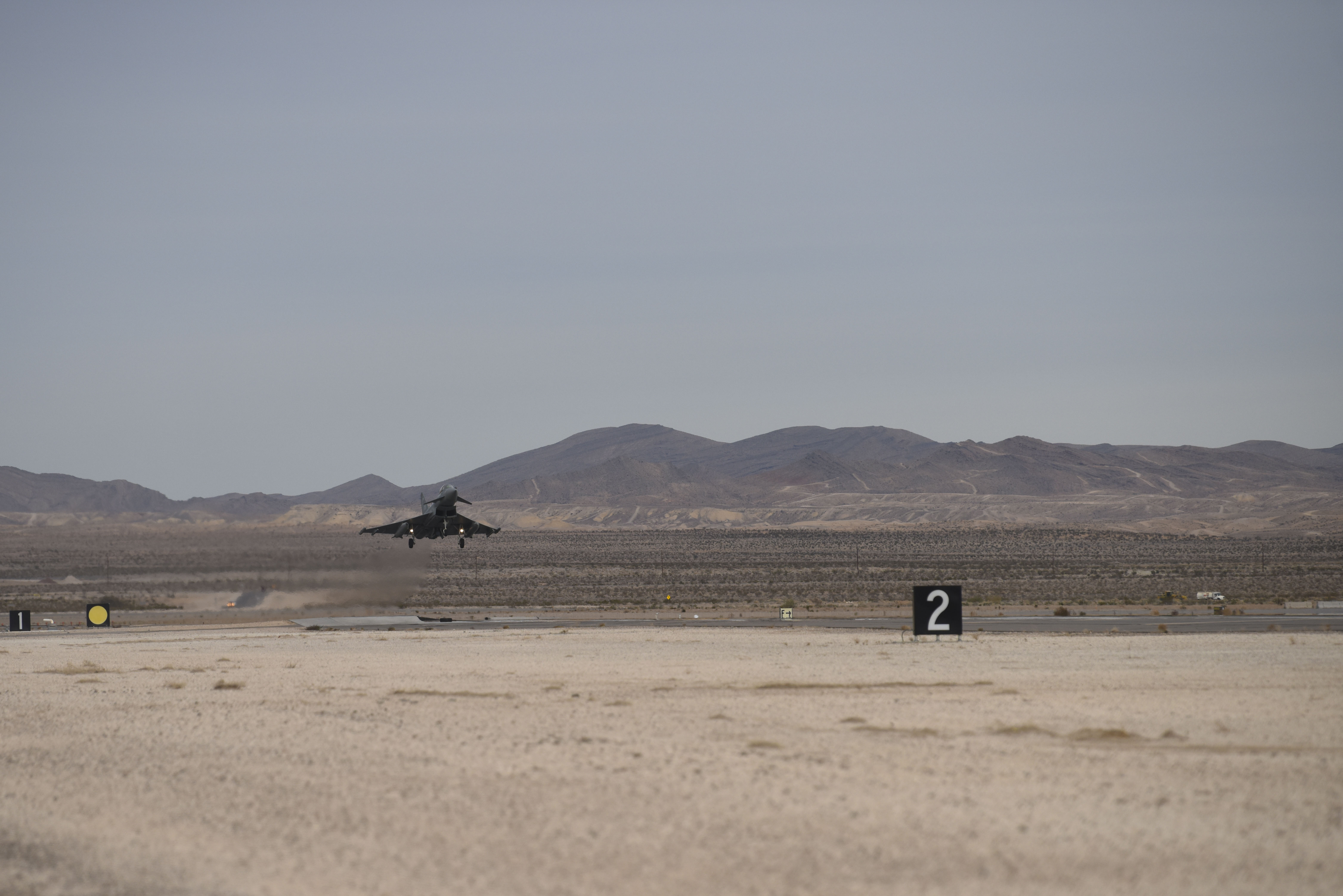 Image shows RAF Typhoon taking off from airstrip.