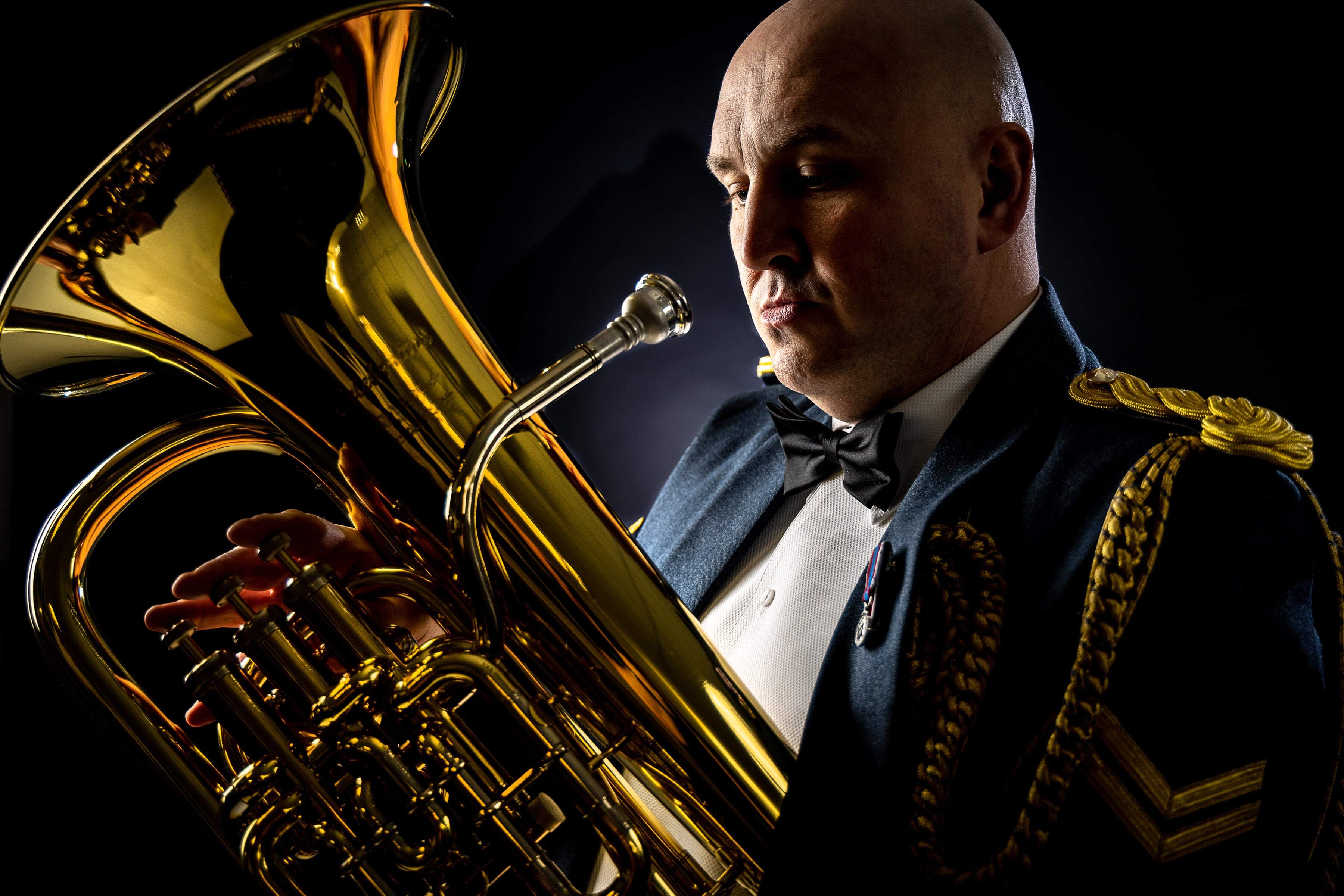 RAf Musician holding his brass instrument, contemplating