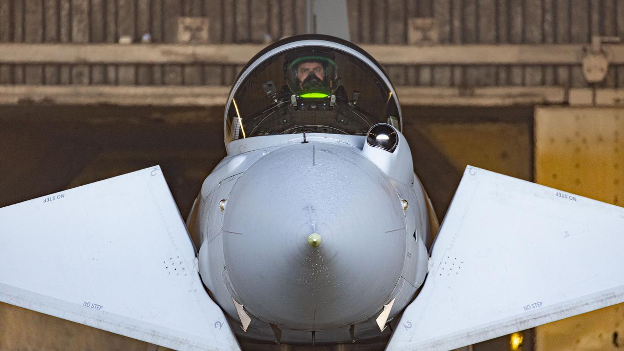 Close up external front view of an RAF Typhoon aircraft with pilot sat in the cockpit