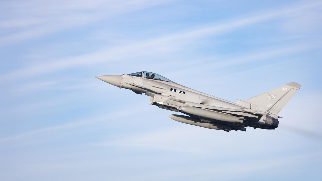 RAF Typhoon flying against blue cloudy sky