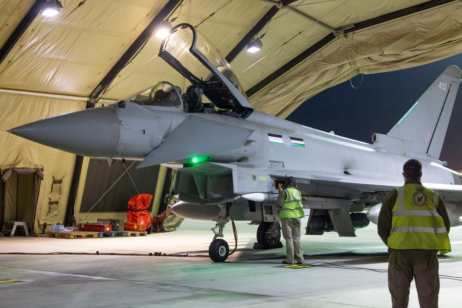 A 12 Sqn Typhoon with it pilot in the cockpit and ground personnel are making final checks prior departure.