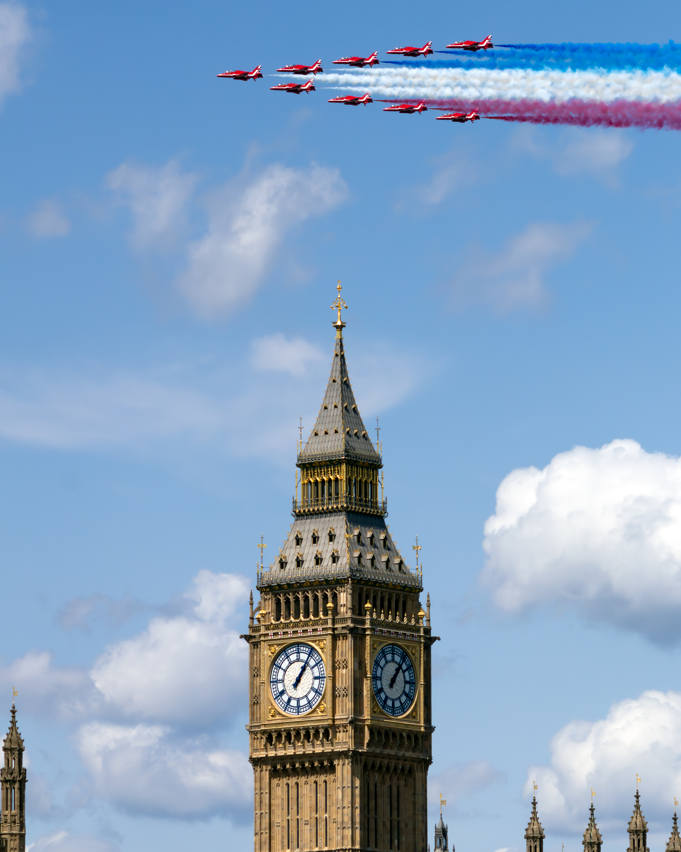 "Red Arrows Big Ben Flypast". Nine Hawk T1s of the Red Arrows fly in formation over the clocktower of Big Ben, trailing red, white, and blue smoke.