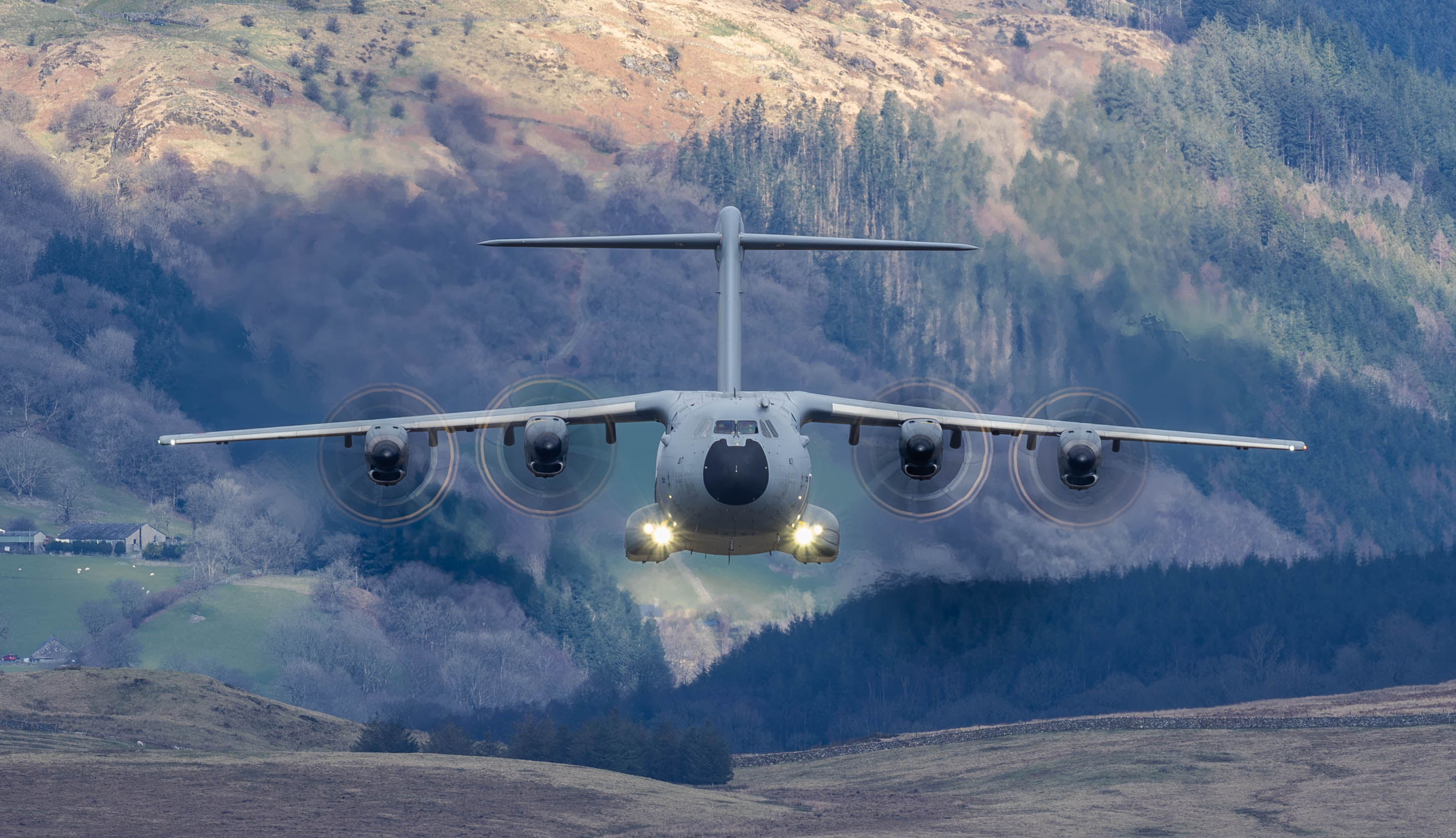 "A400M." An RAF A400M in low flight over countryside, flying towards the camera.