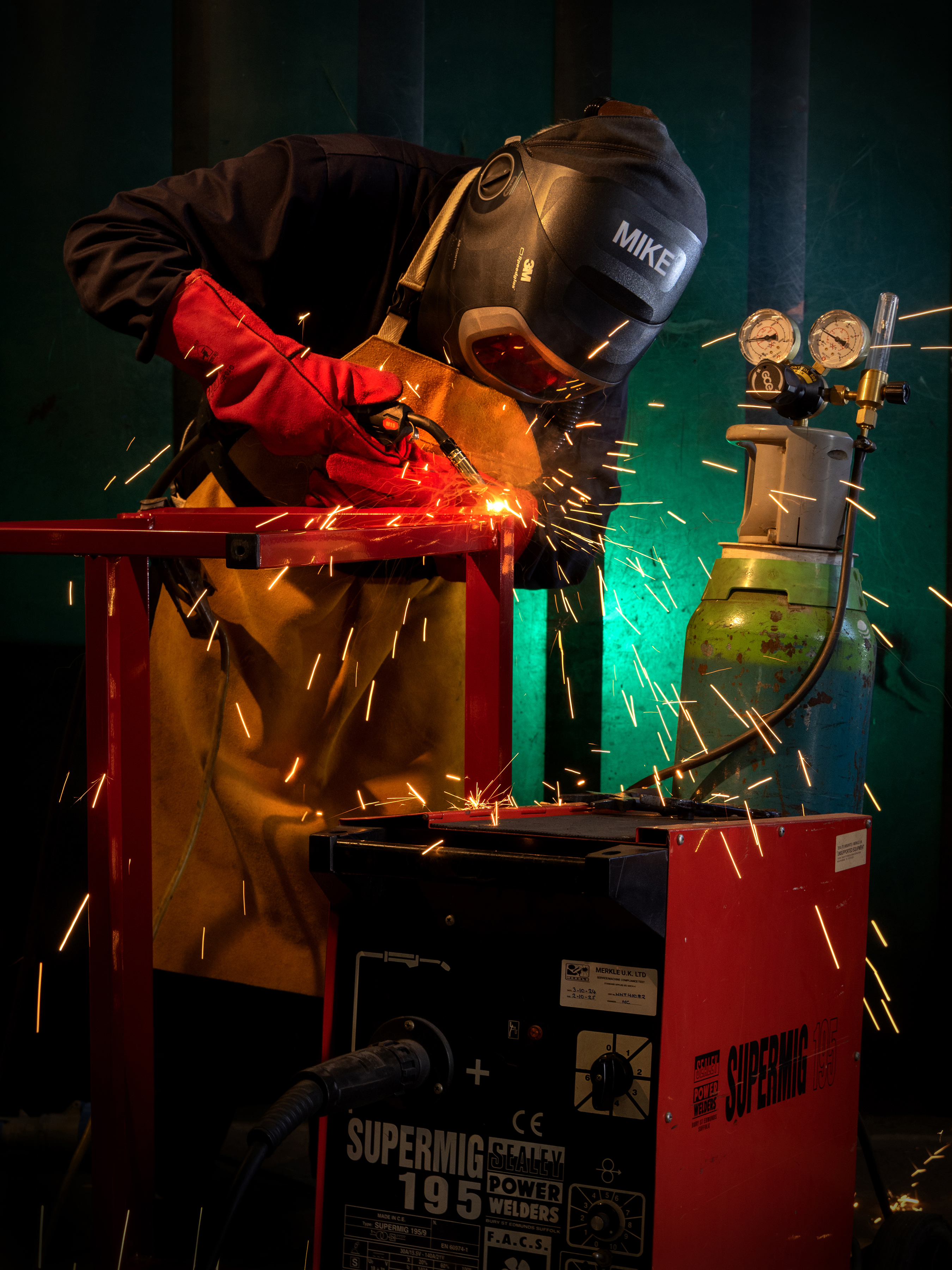 "Welder". An RAF welder hard at work. Orange sparks fly as they do.