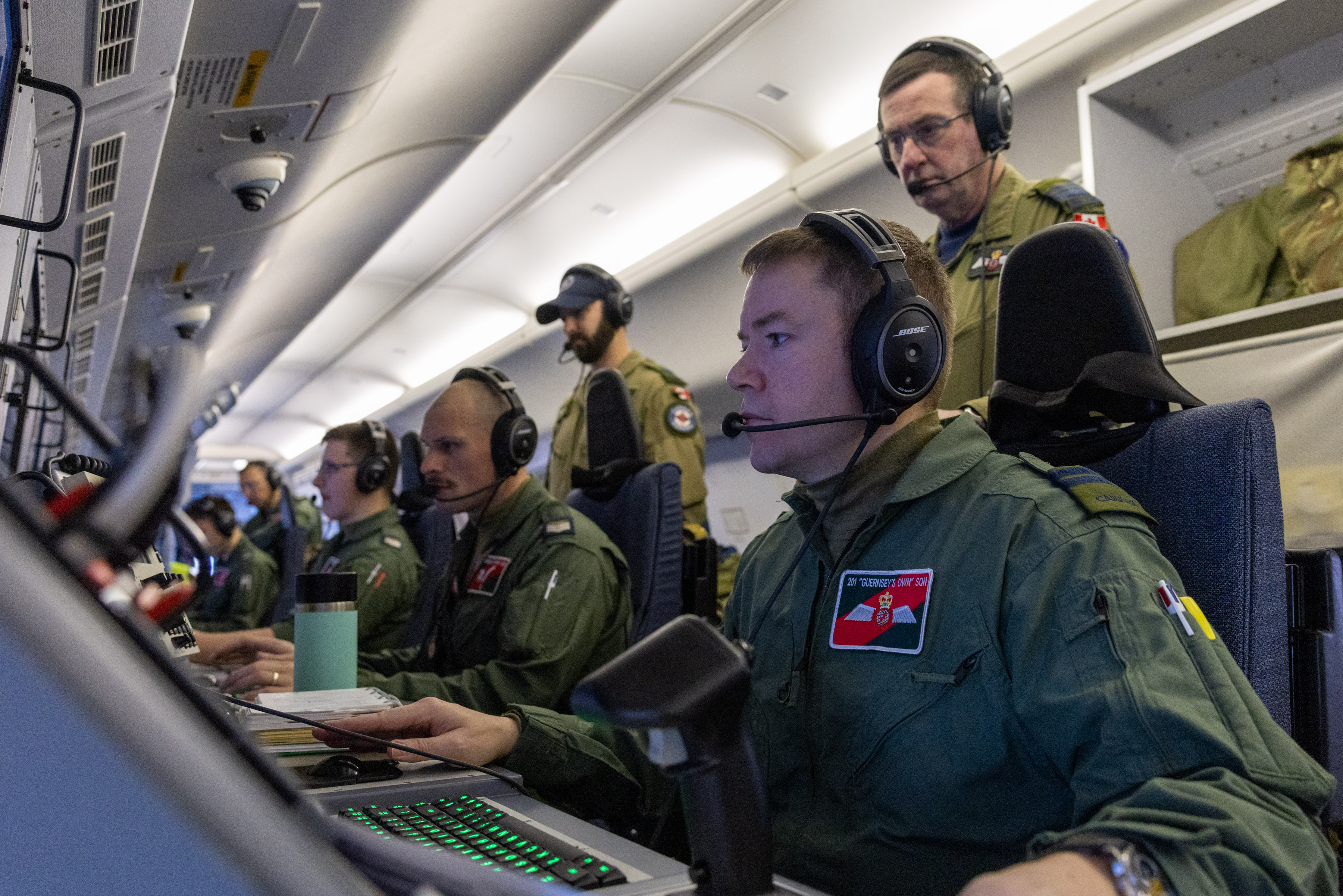 RAF Personnel at work at their stations onboard an RAF P-8A aircraft.